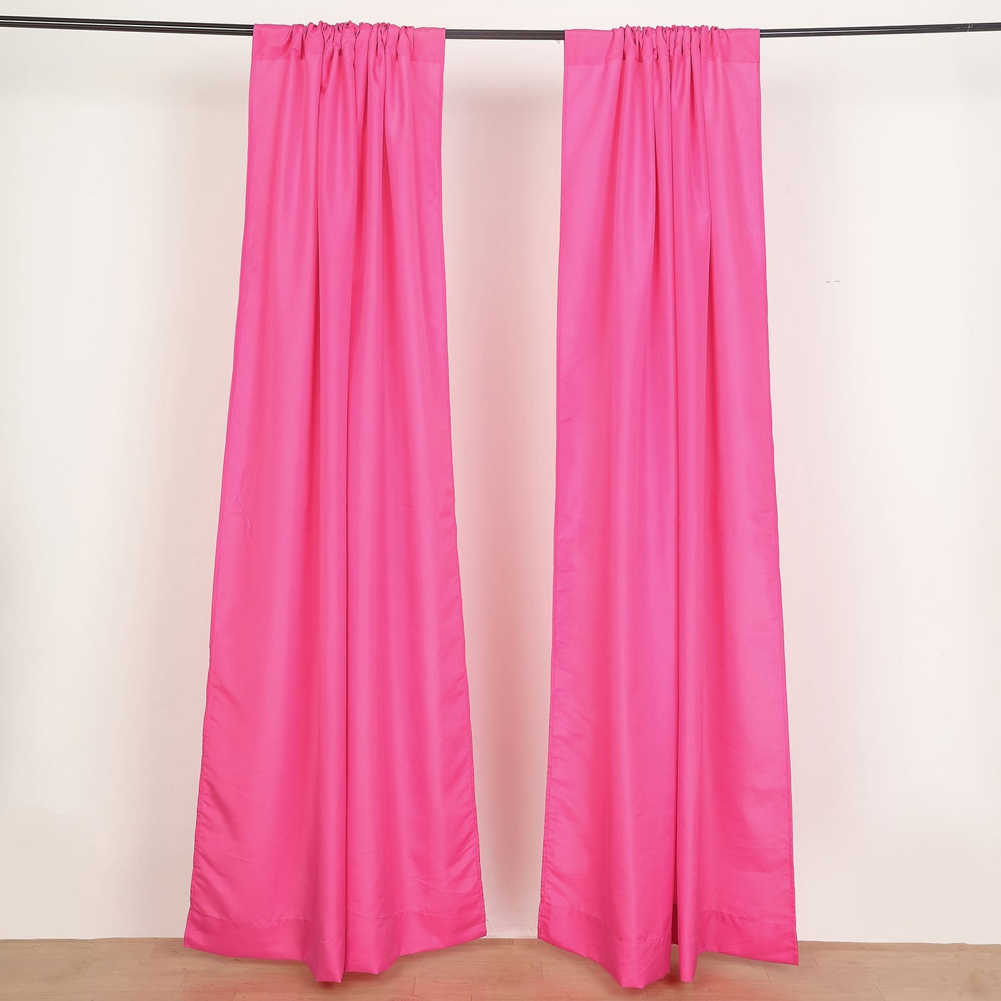 Fuchsia polyester backdrop drape curtains with rod pockets.