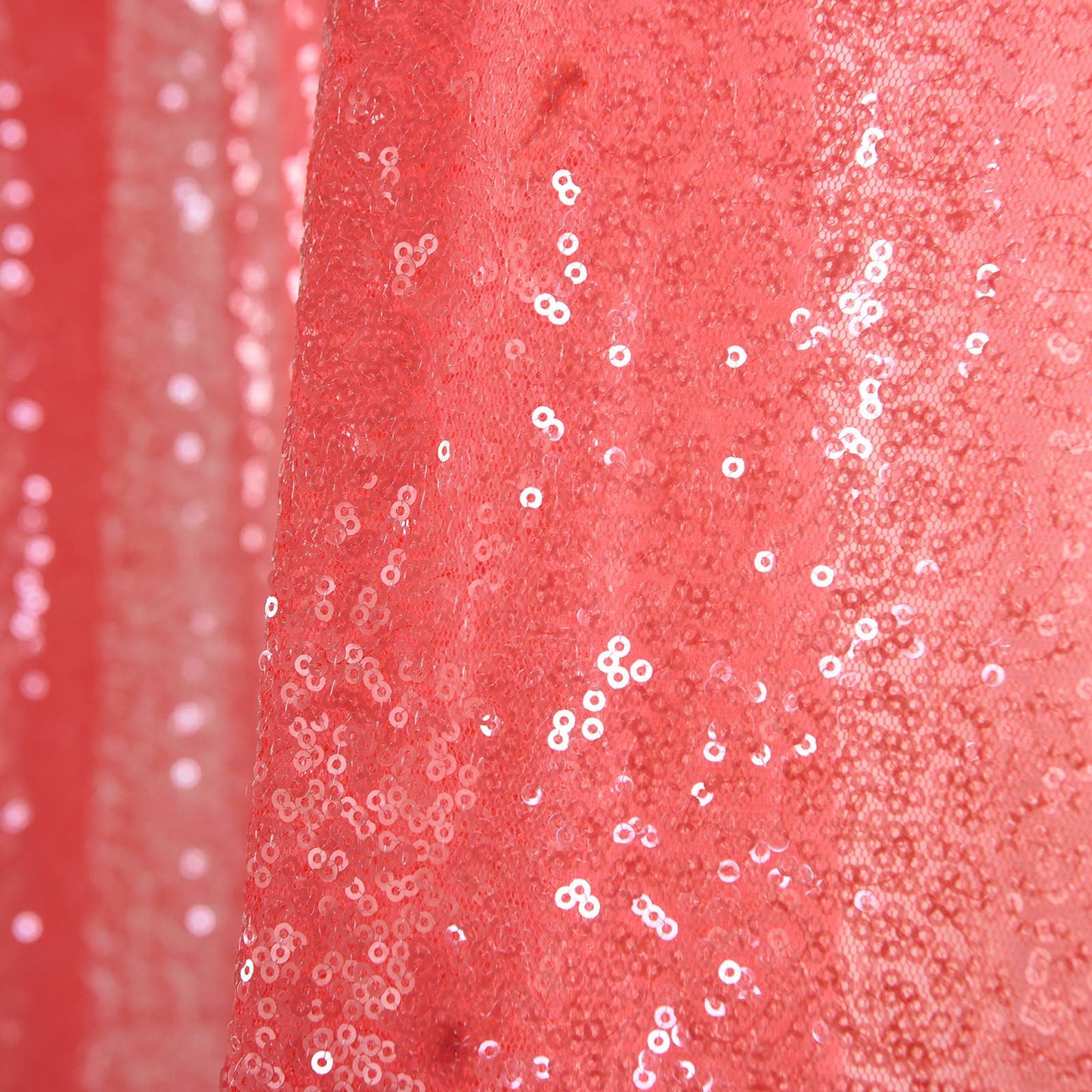 Coral sequin curtains with rod pocket window treatment panels.