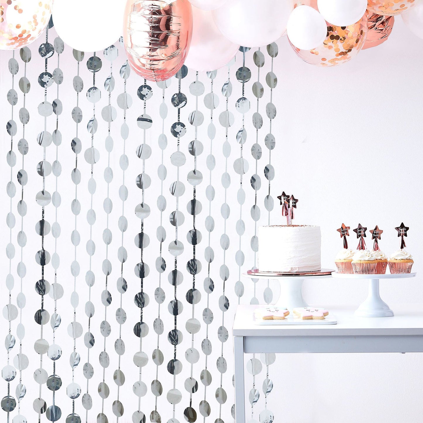 Metallic silver foil fringe curtain backdrop for party decor.