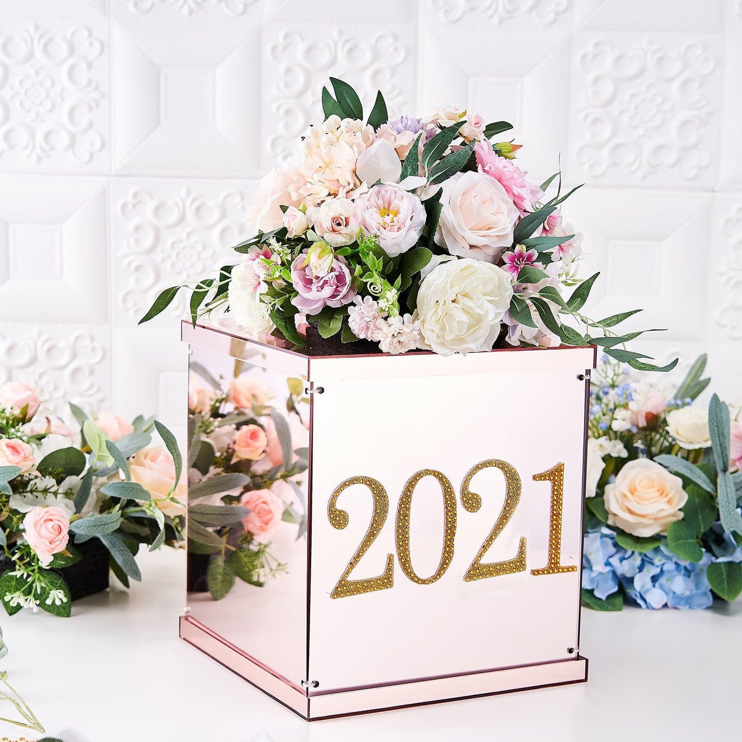 Gold decorative rhinestone number sticker "2021" on a floral arrangement box.