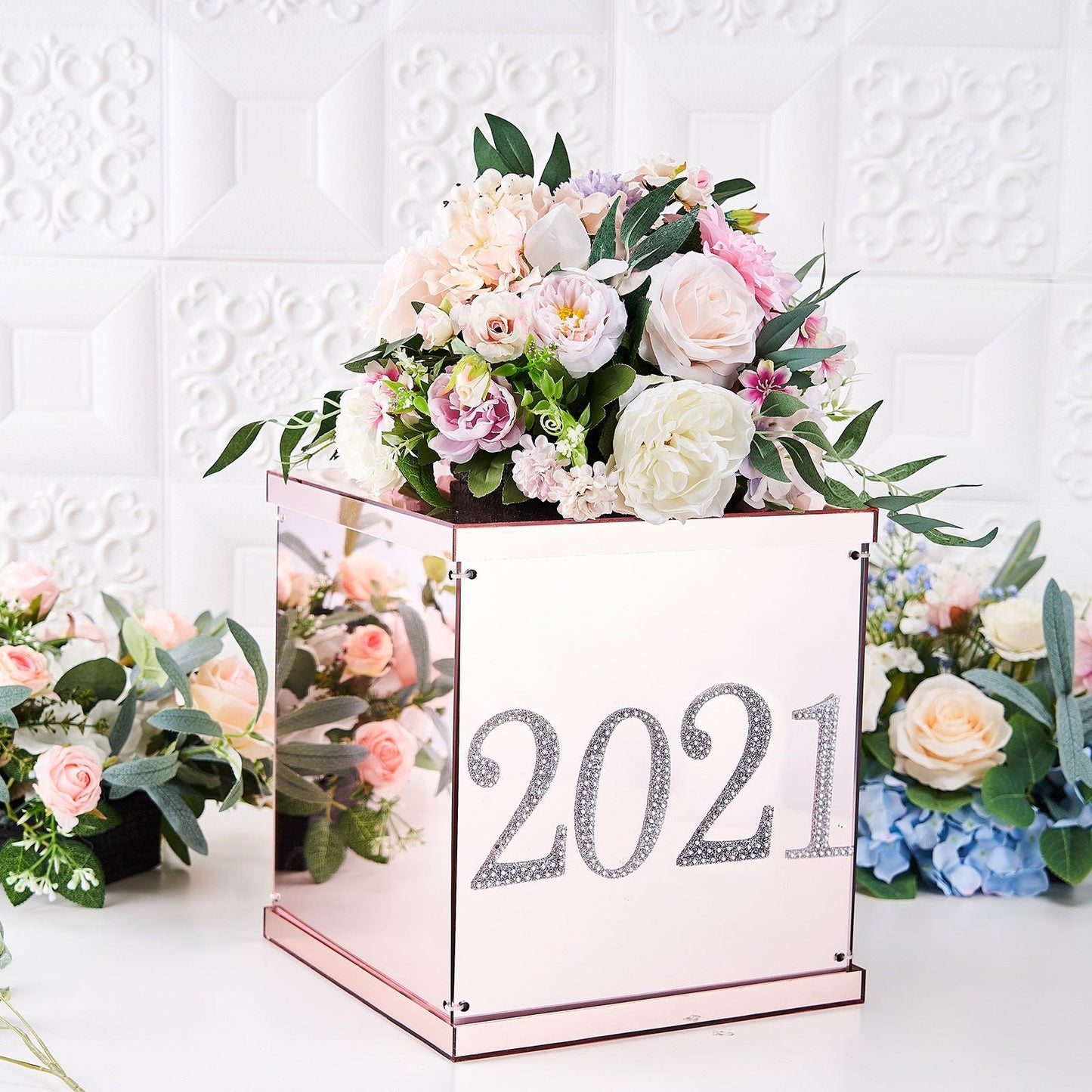 Silver decorative rhinestone number stickers on a floral arrangement.