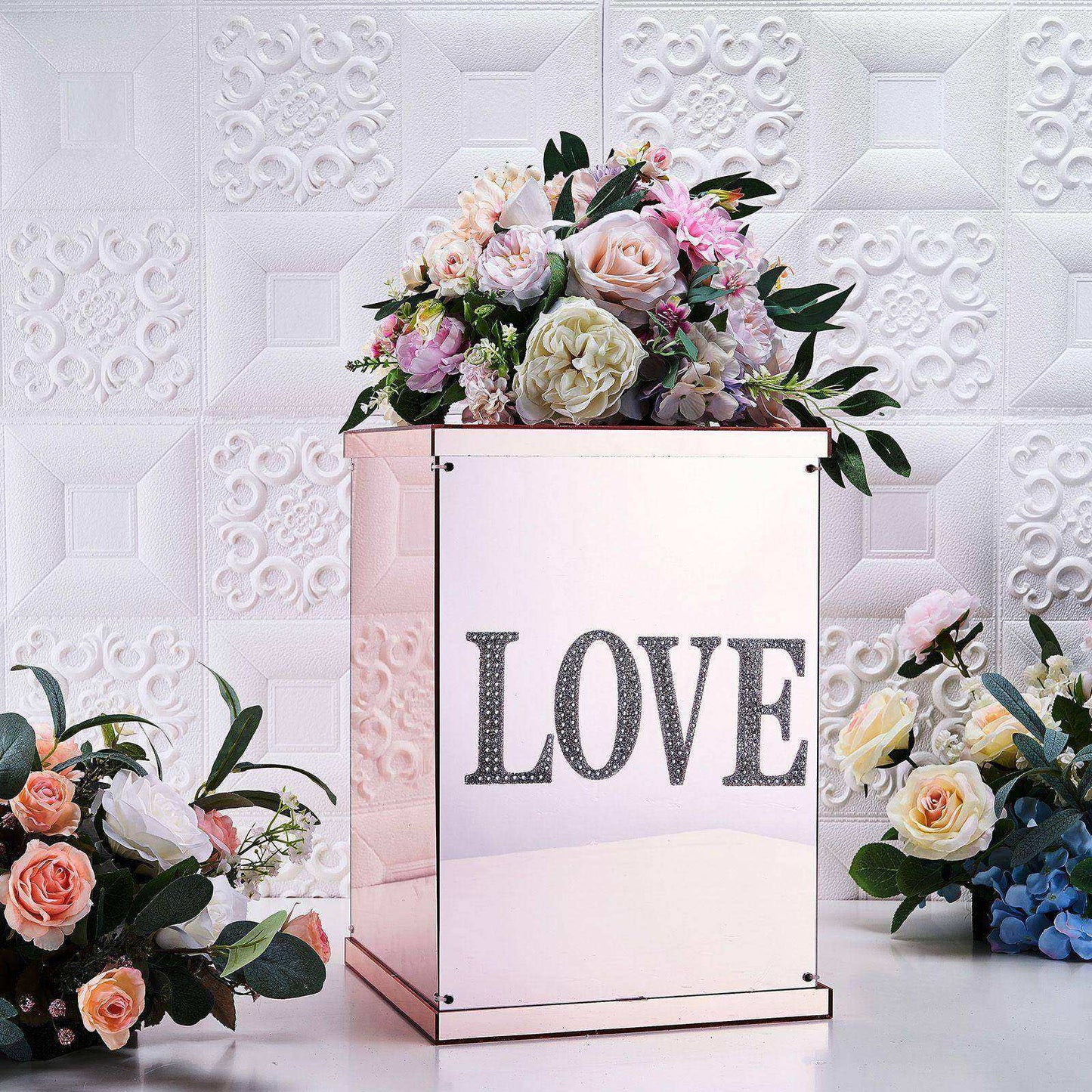 Silver decorative rhinestone letter stickers on a floral display.