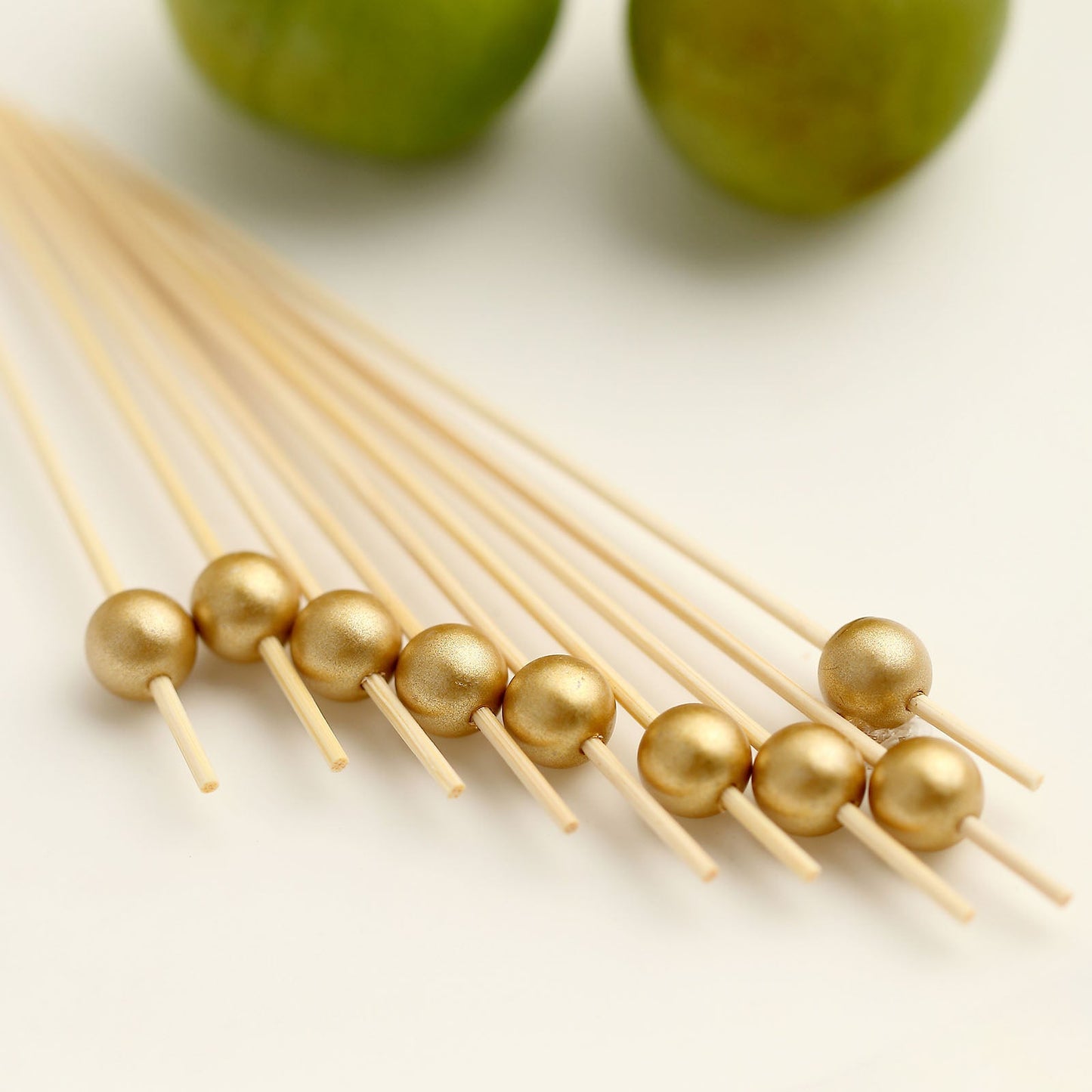 Gold pearl bamboo skewers for cocktails and appetizers. Eco-friendly stir sticks.