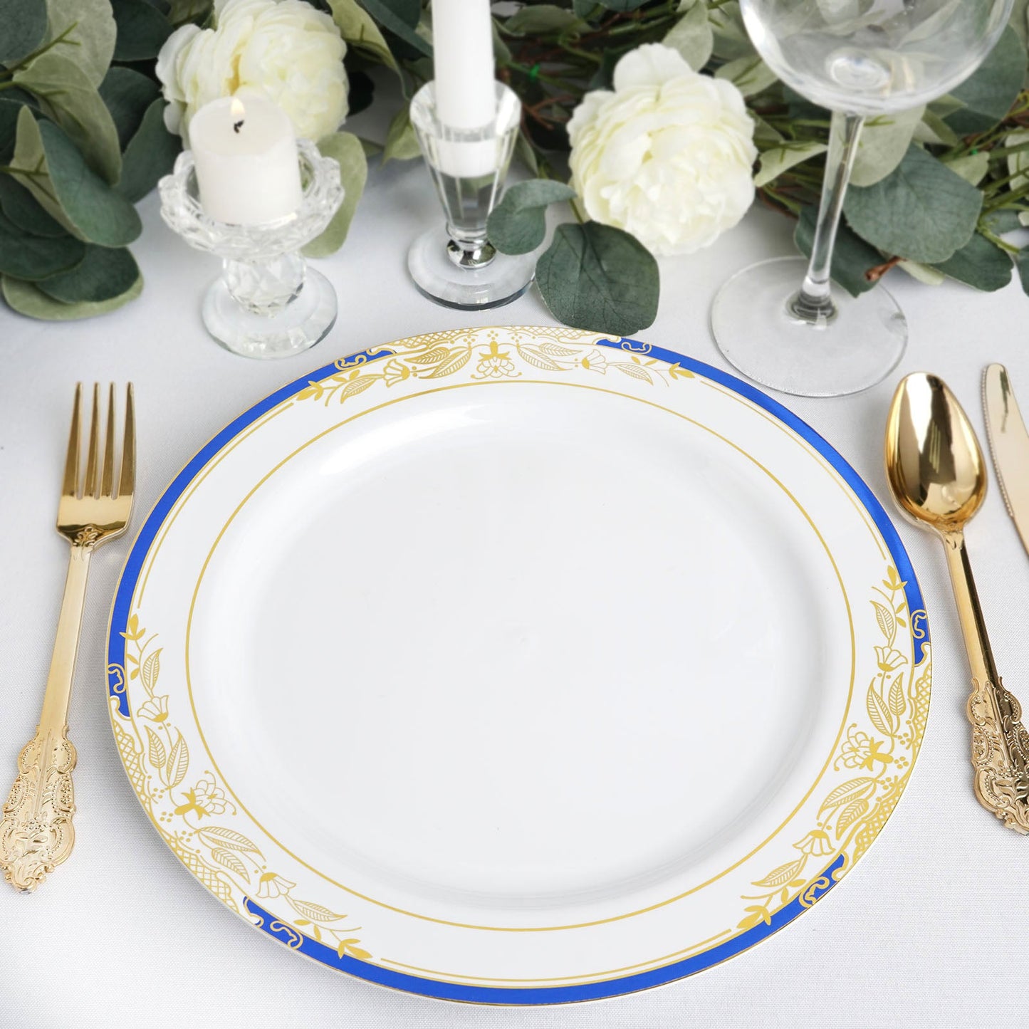 White dinner plate with royal blue rim and gold vine design.