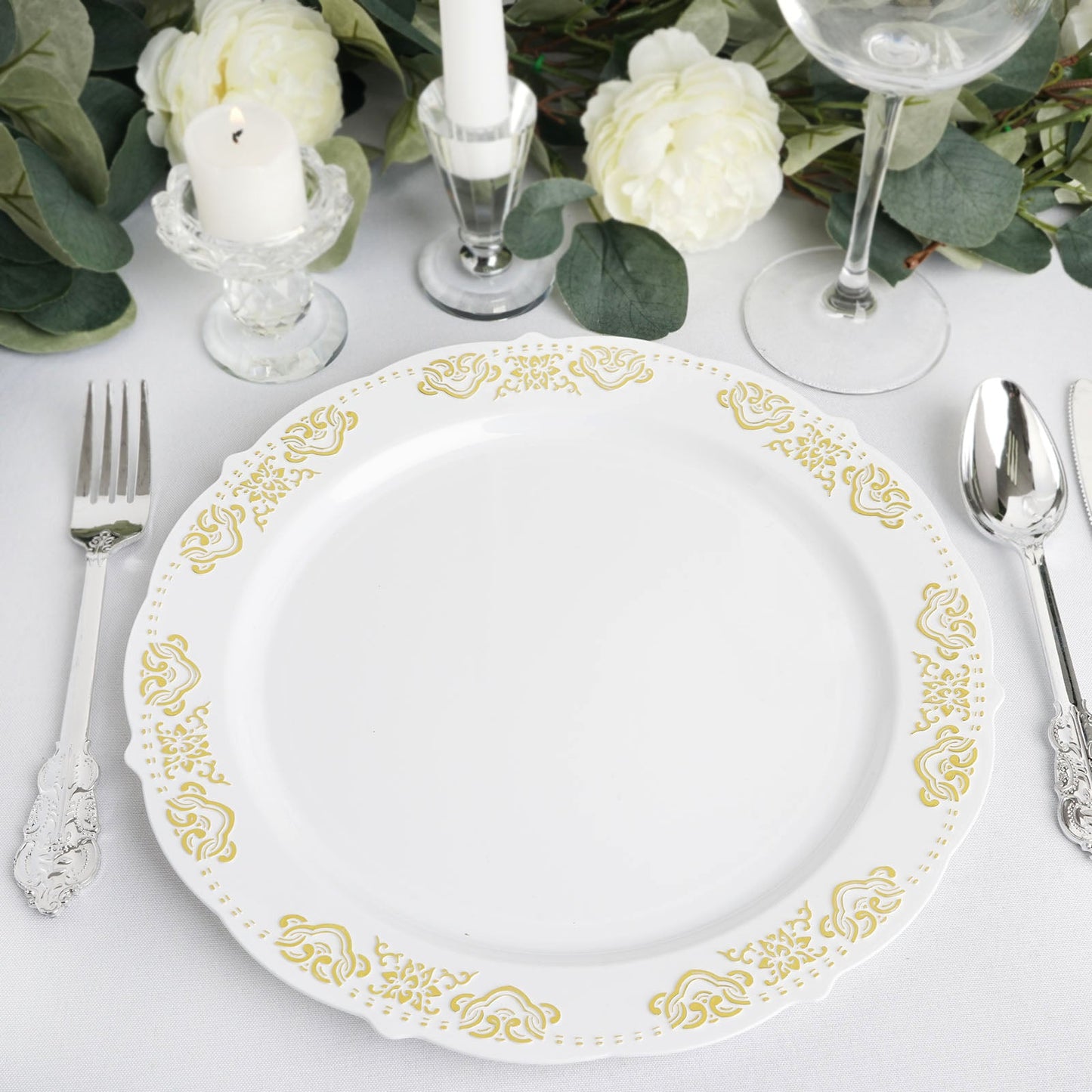 Gold embossed white plastic dinner plate with scalloped edges.