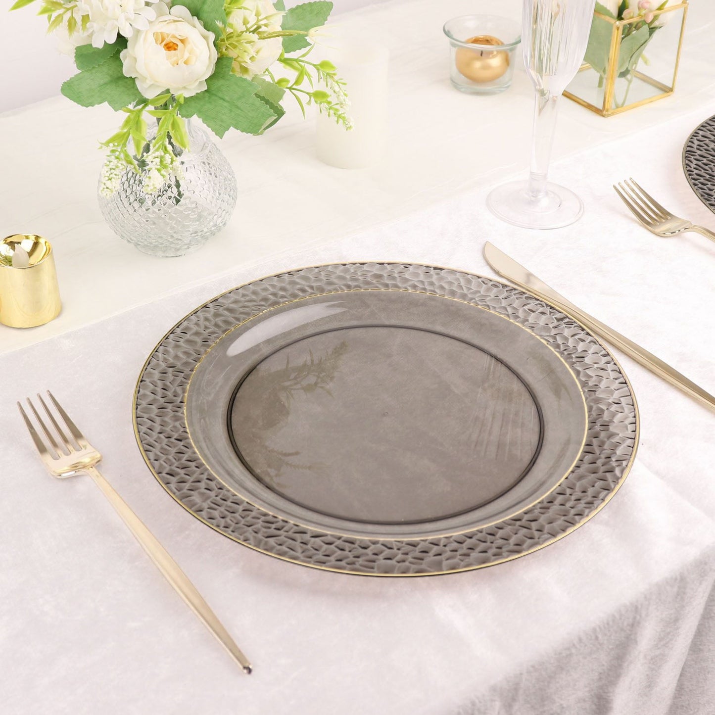 Opaque black hammered design dinner plate with gold rim.