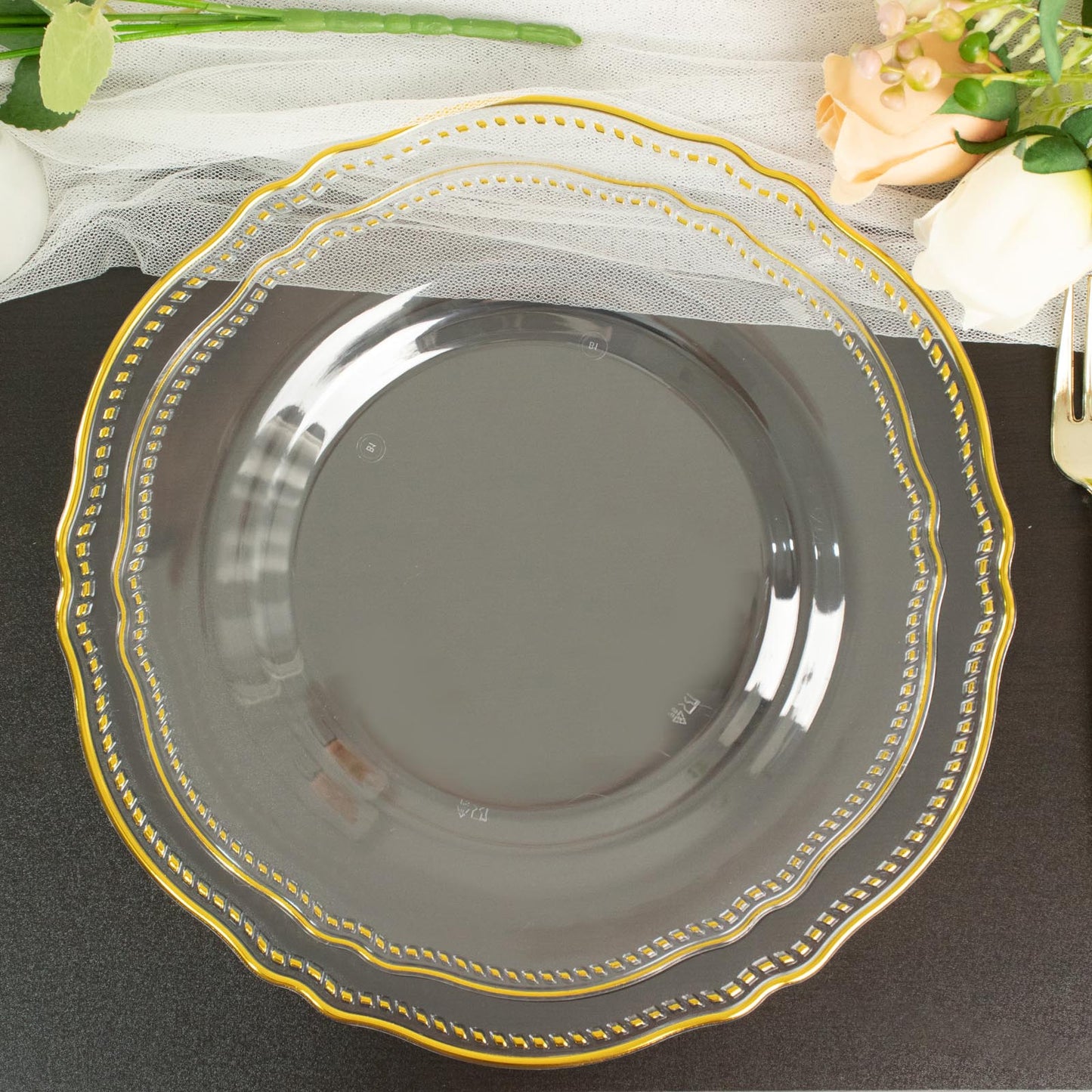 Elegant clear glass plate with gold trim design, perfect for special occasions.