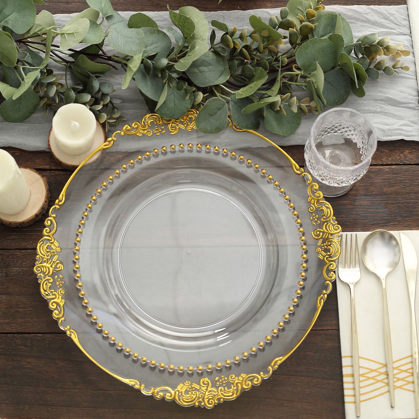 Clear disposable dinner plate with gold beaded rim, perfect for festive occasions.