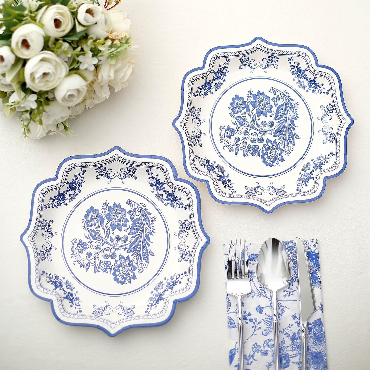 White and royal blue damask floral disposable dessert plates.