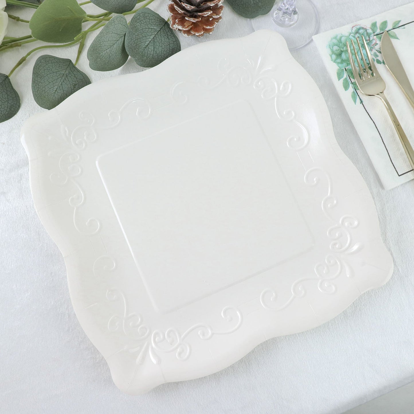 White vintage square dinner paper plate with embossed scroll design.
