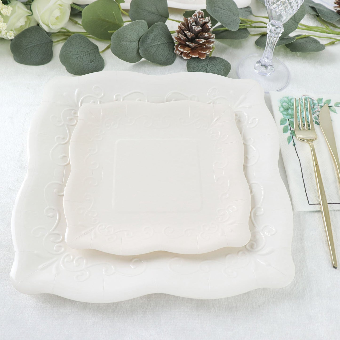 White vintage square appetizer dessert paper plates with embossed scroll design.