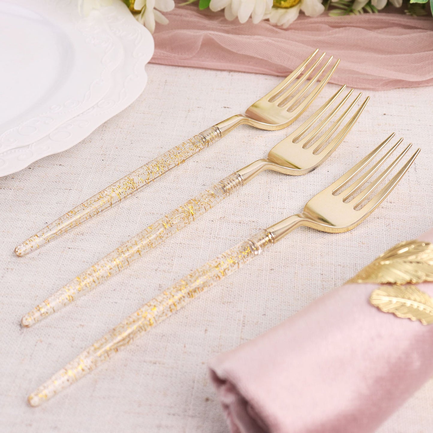 Gold glittered disposable forks, plastic silverware cutlery.