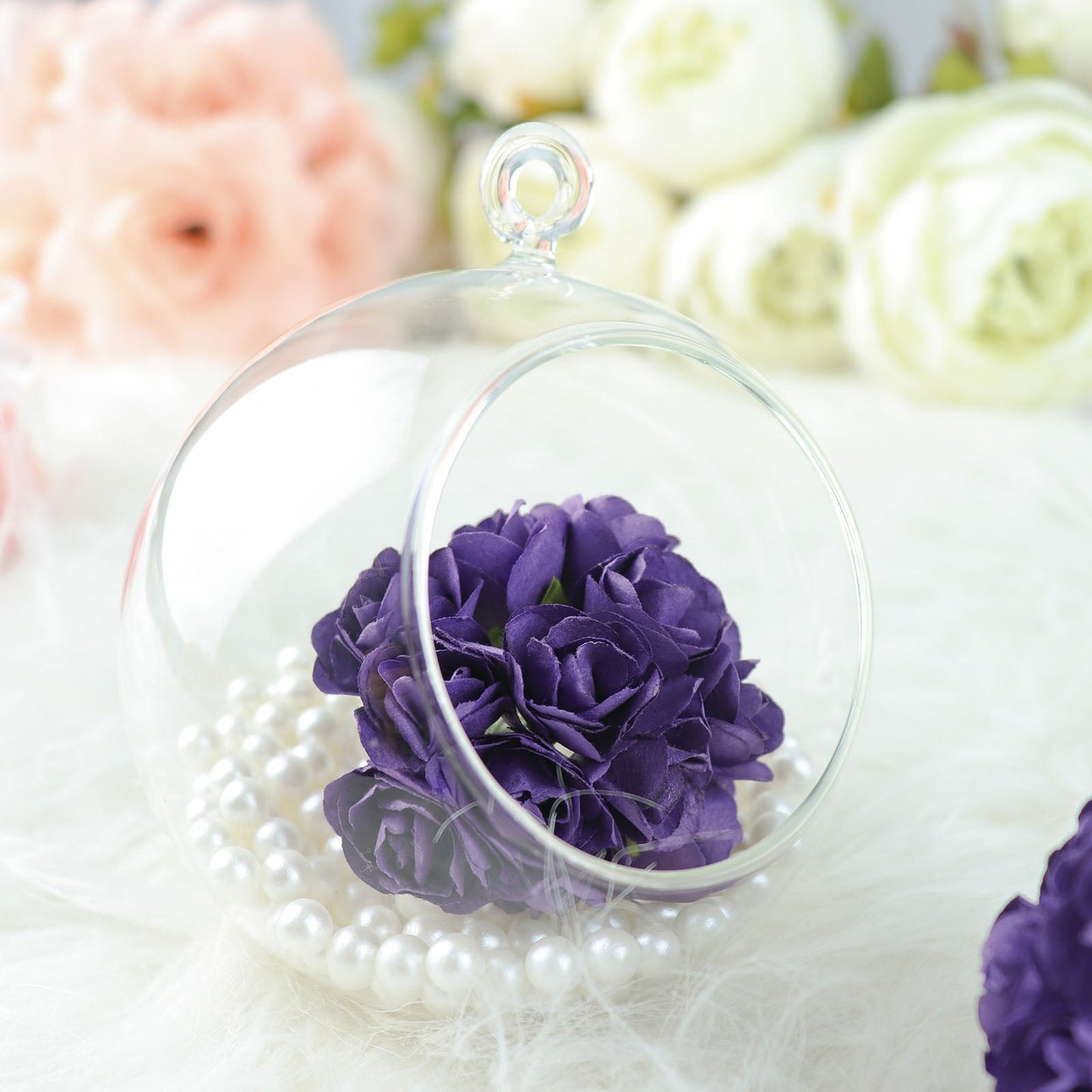 Purple mini craft roses in a glass orb with pearls.