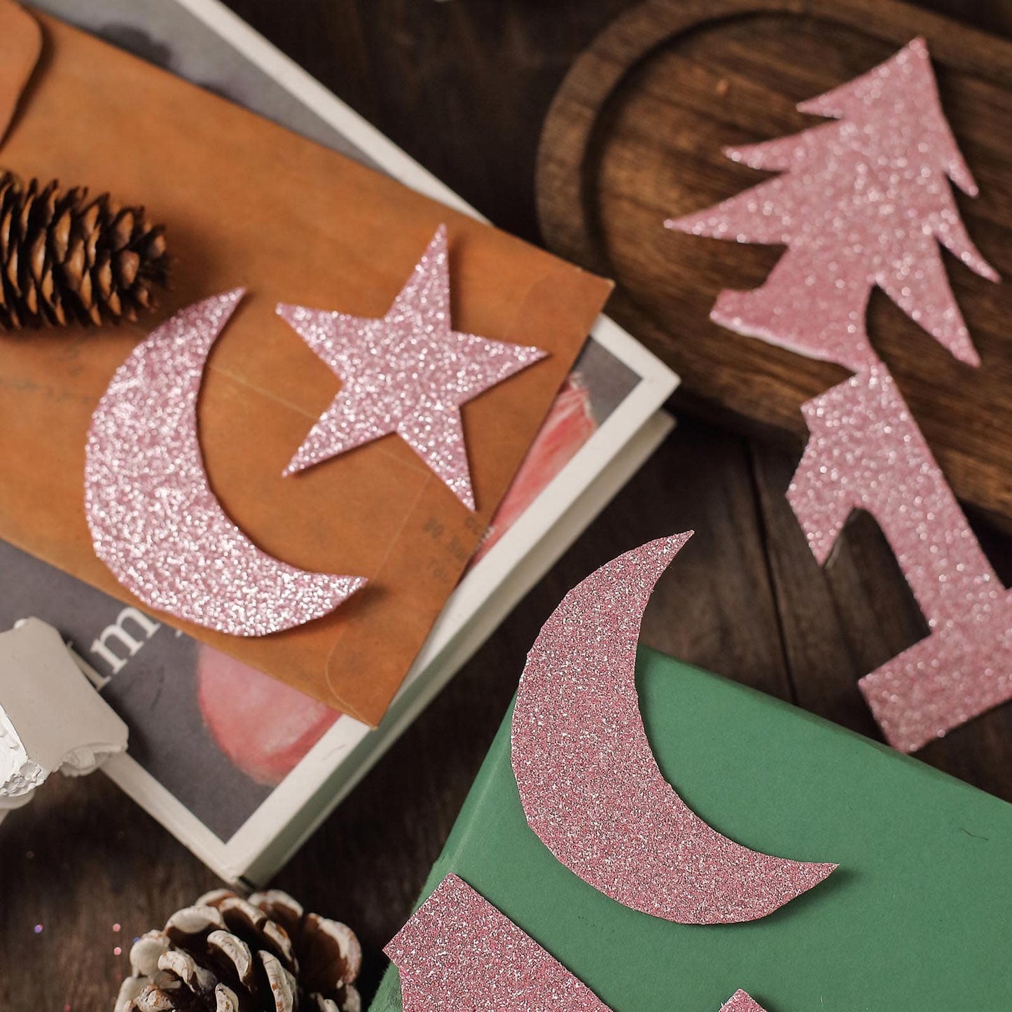 Pink self-adhesive glitter foam sheets cut into shapes for DIY crafts.