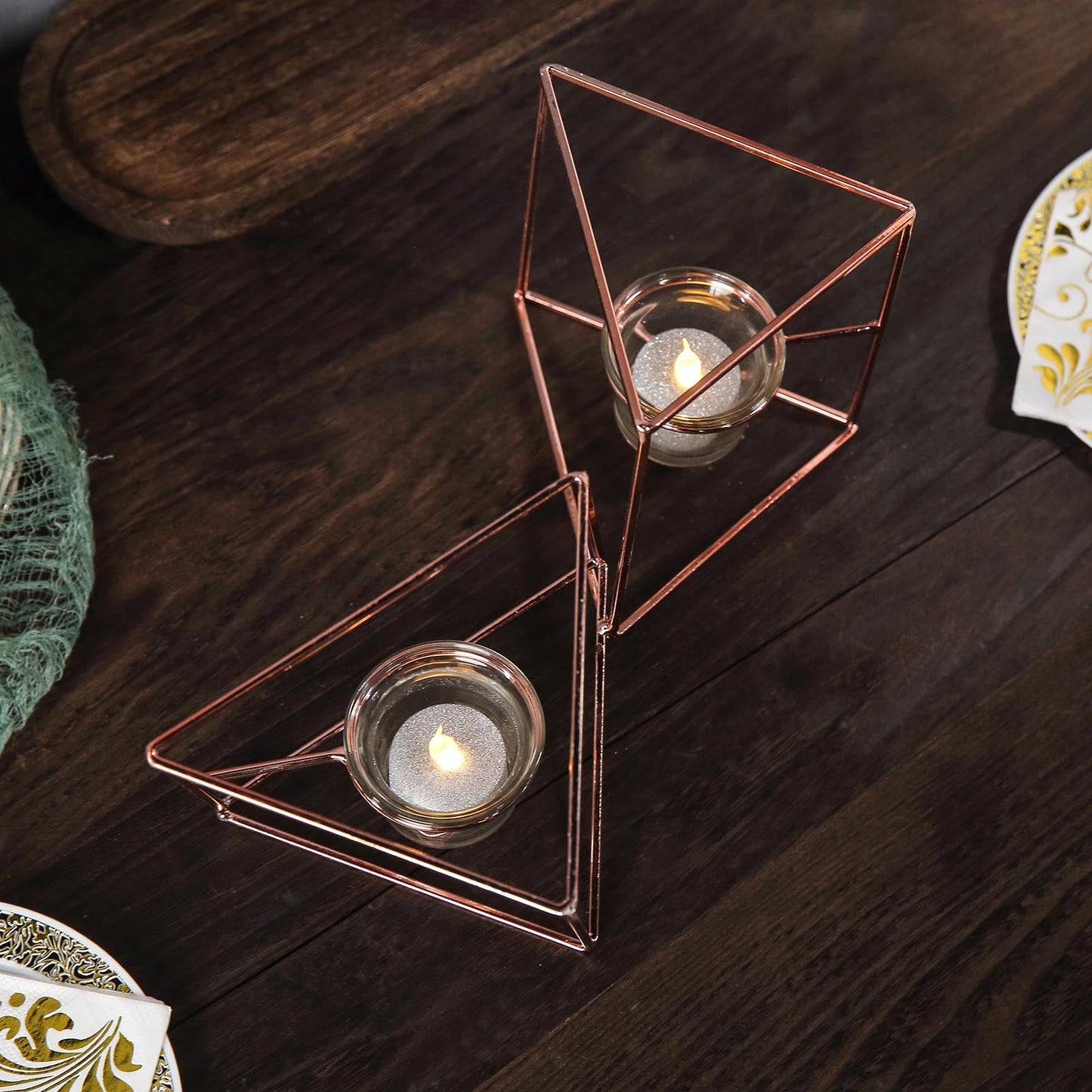 Rose gold geometric candle holder set with glass votive holders.
