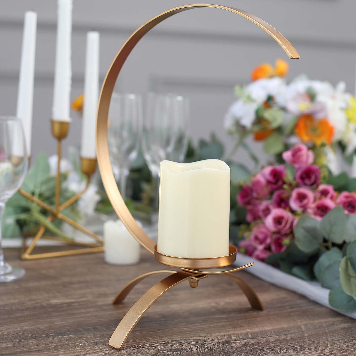 Gold moon-shaped metal candle holder centerpiece with a tealight.