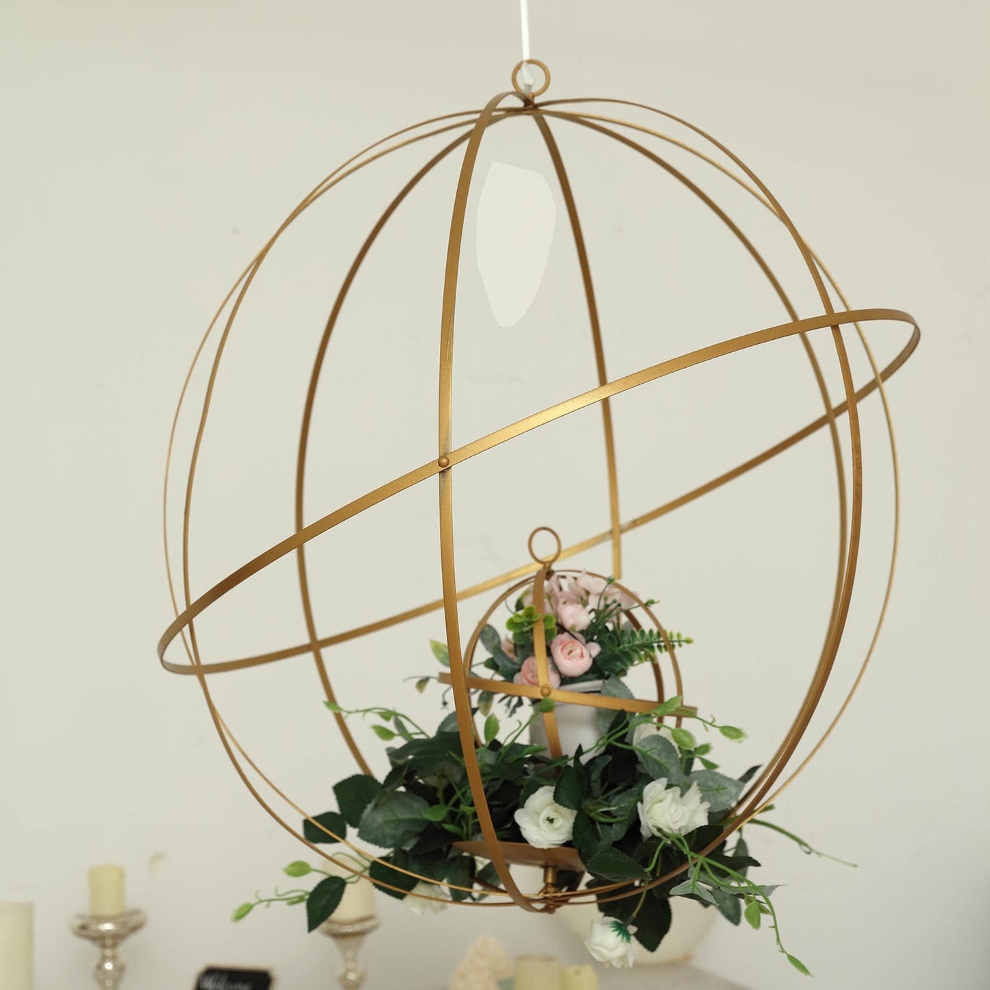 Gold open frame centerpiece ball with floral display.