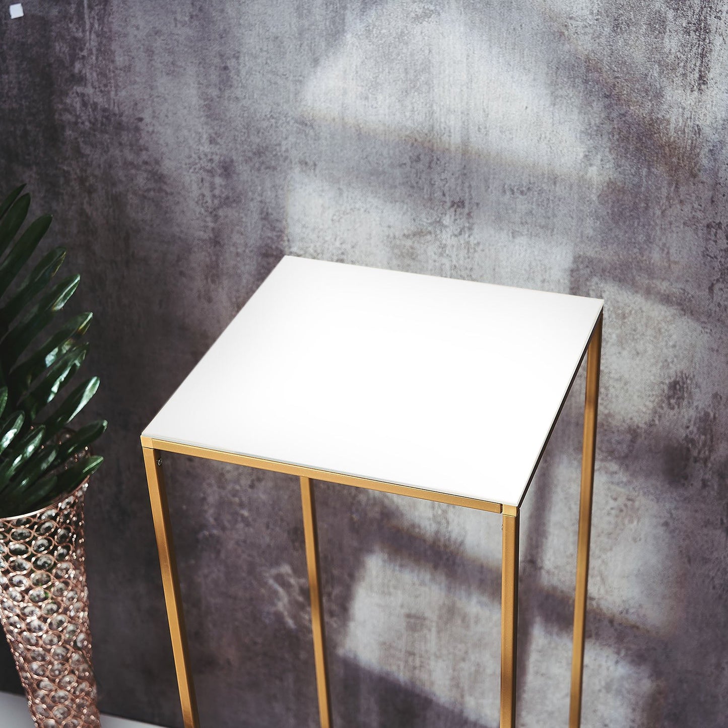 White acrylic plexiglass sheet on a gold metal stand.
