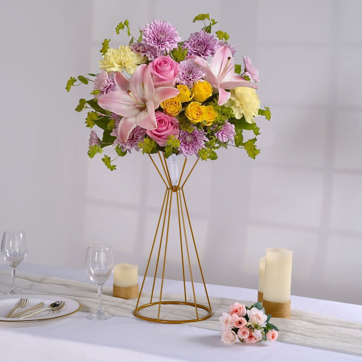 Gold geometric flower stand with floral arrangement, perfect for weddings.