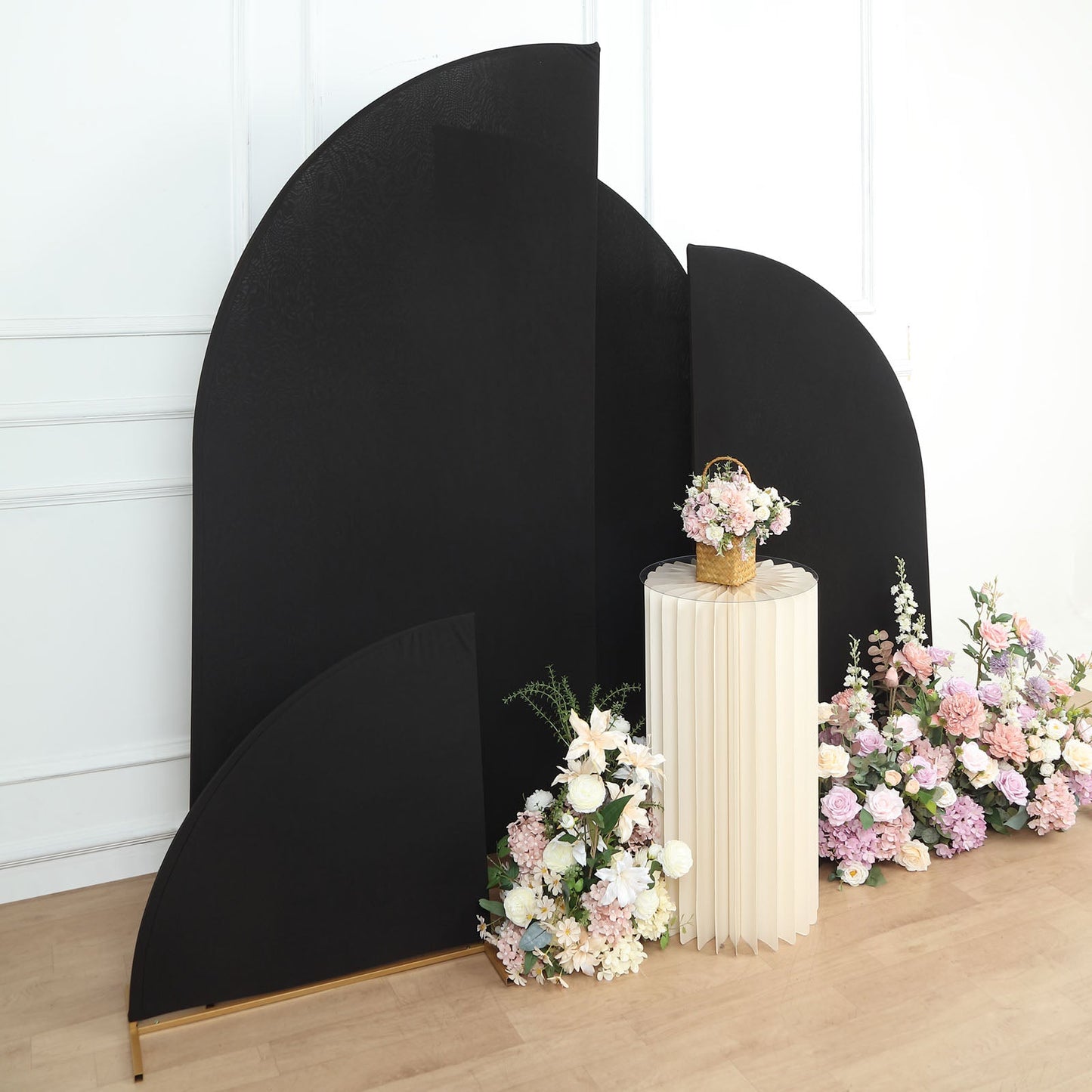 Matte black spandex half moon backdrop stand covers with floral arrangement.