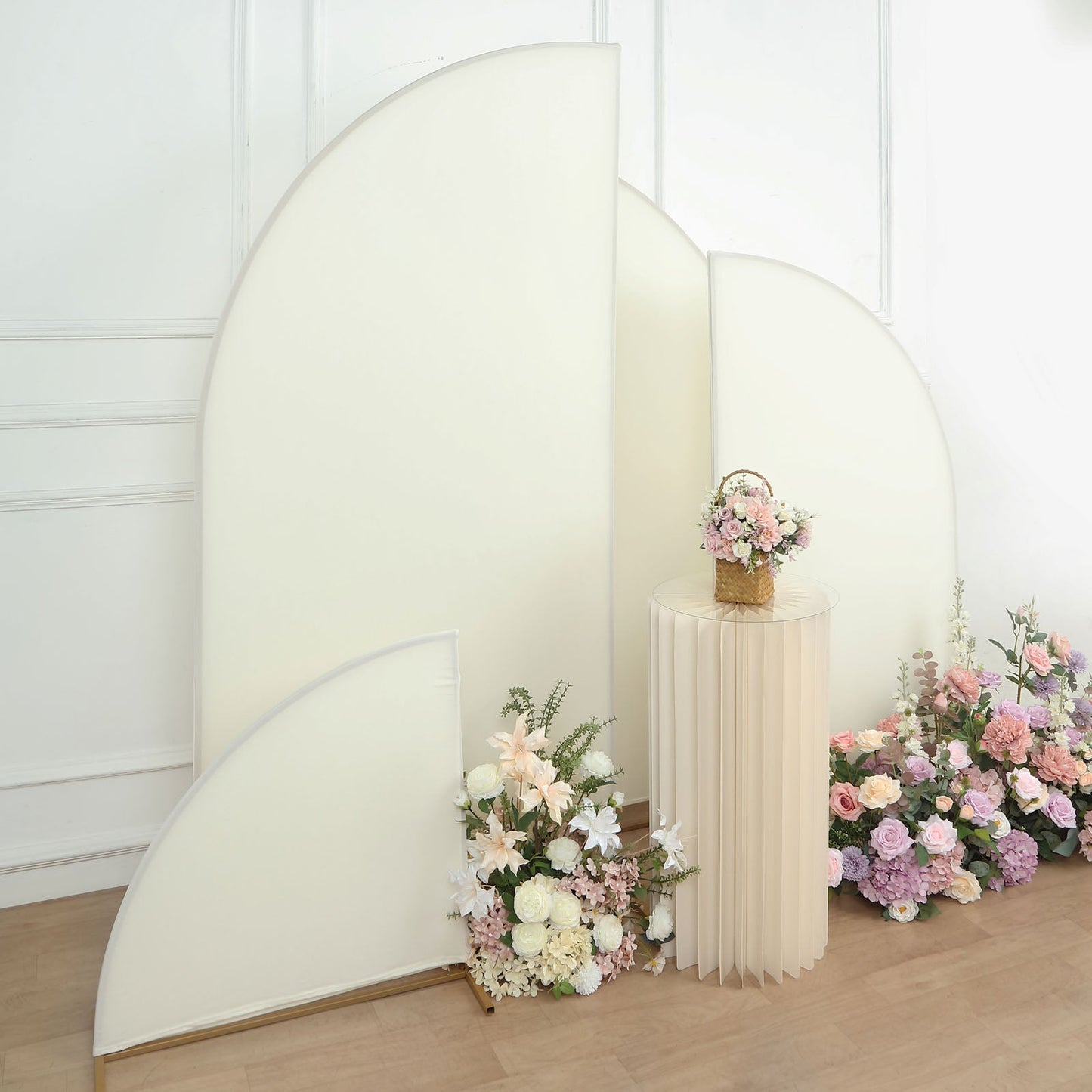 Matte ivory spandex half moon backdrop stand covers with floral arrangement.