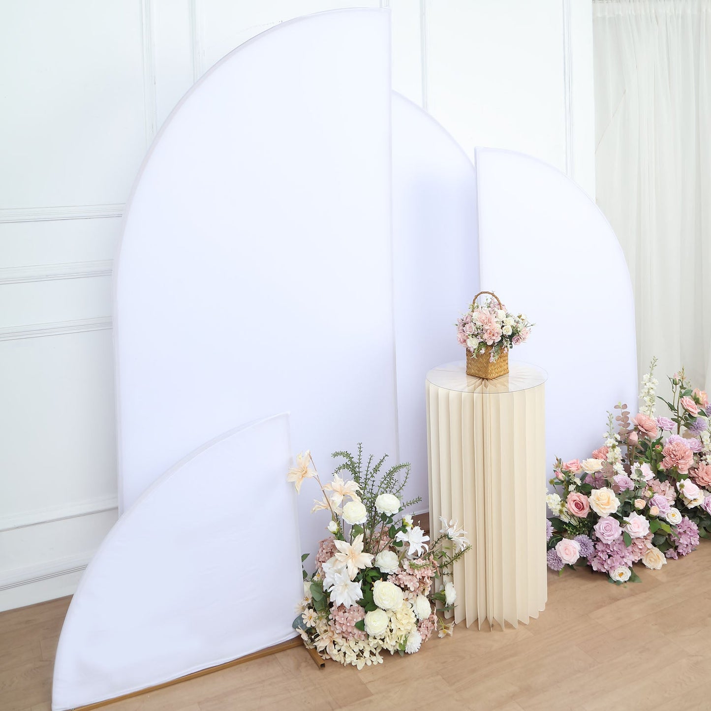 Matte white Chiara backdrop stand covers with floral arrangement.