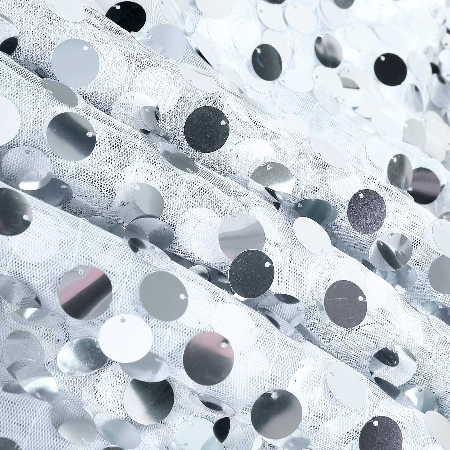 Silver sequin table overlay with shimmering round sequins.