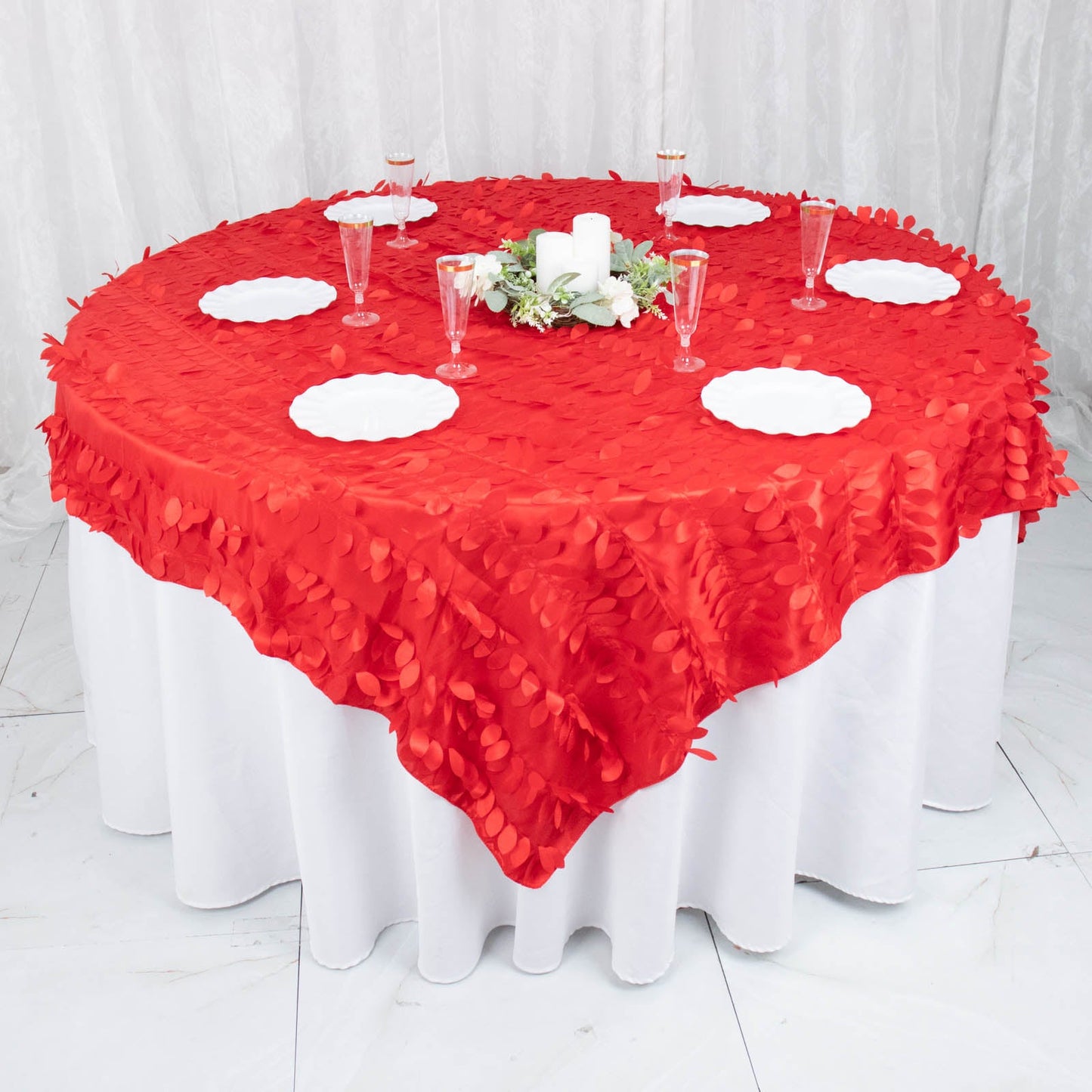 Red 3D leaf petal taffeta fabric table overlay on a round table.