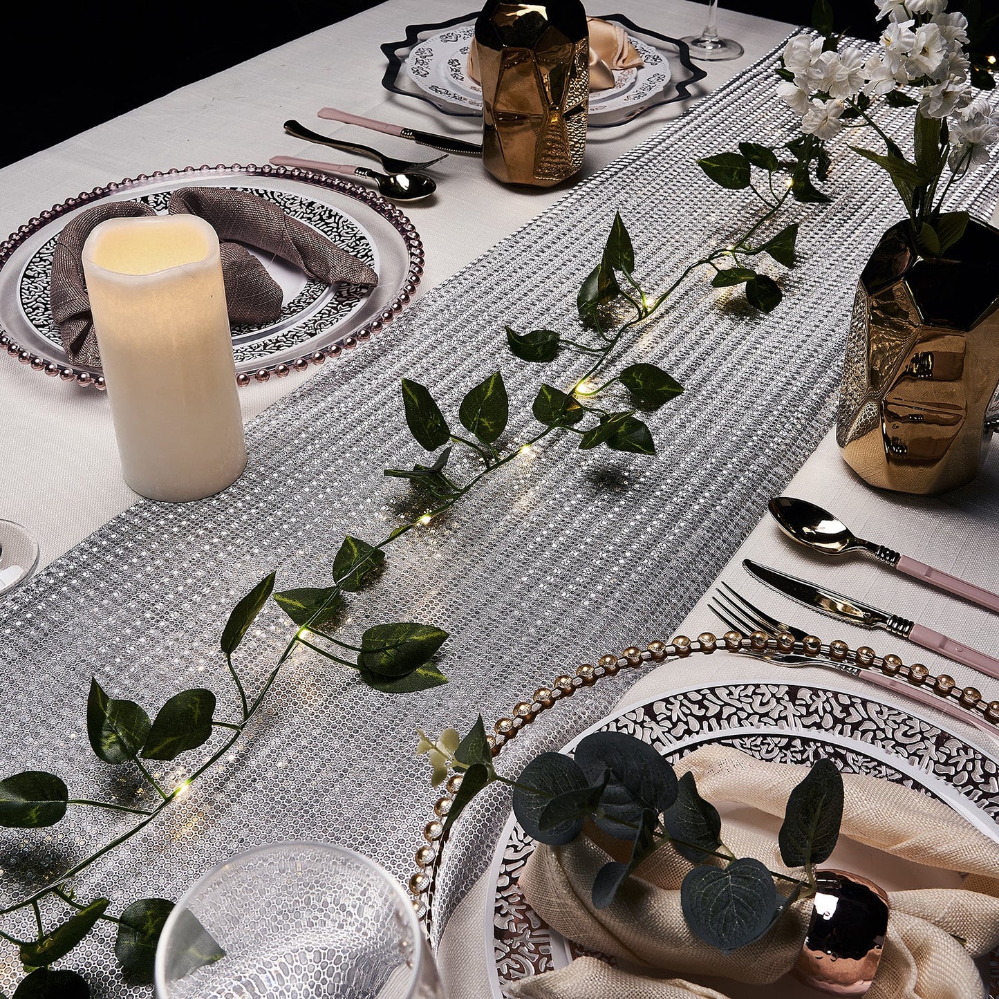 Warm white LED green leaf garland lights on a table setting.