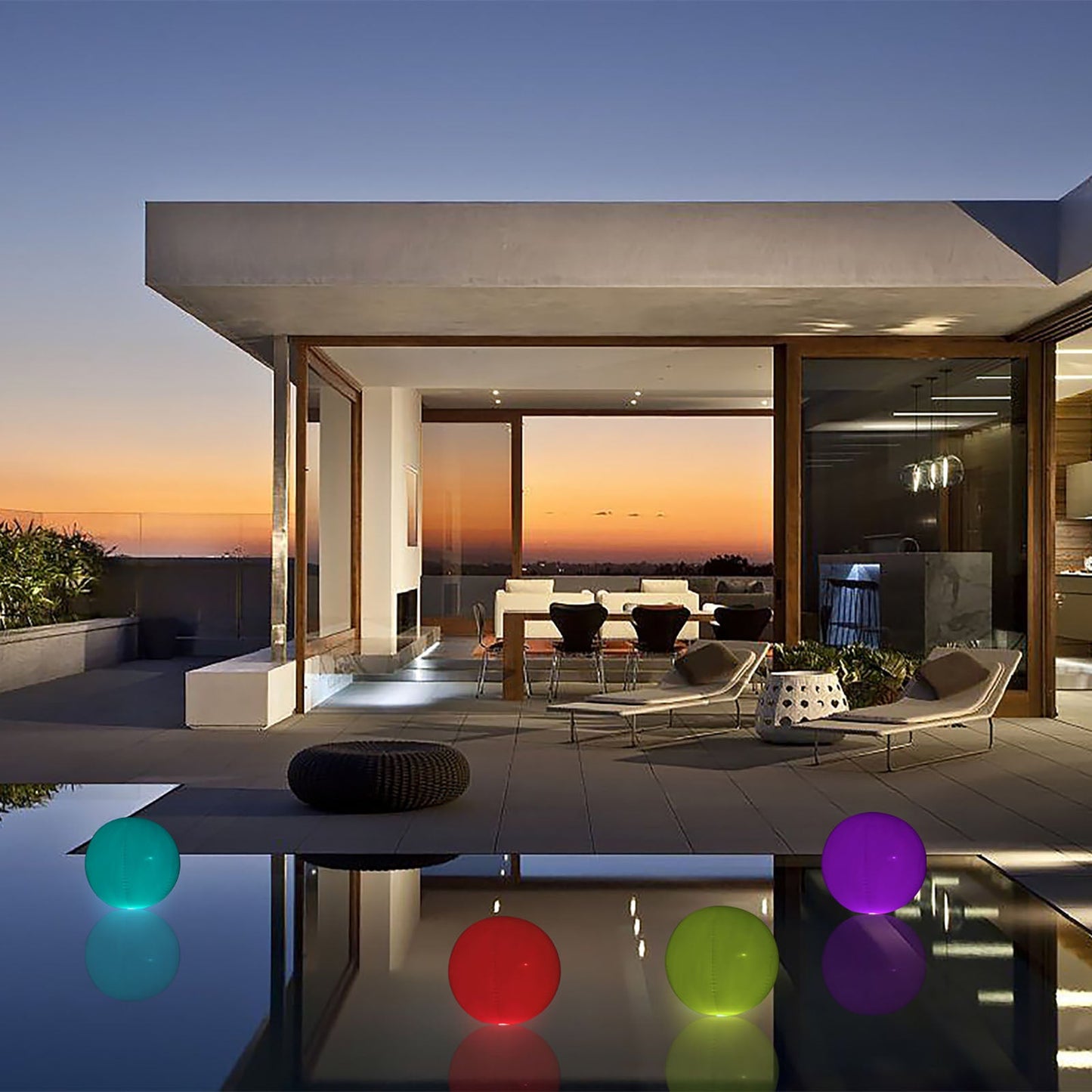 Colorful inflatable garden light up balls by the pool at sunset.