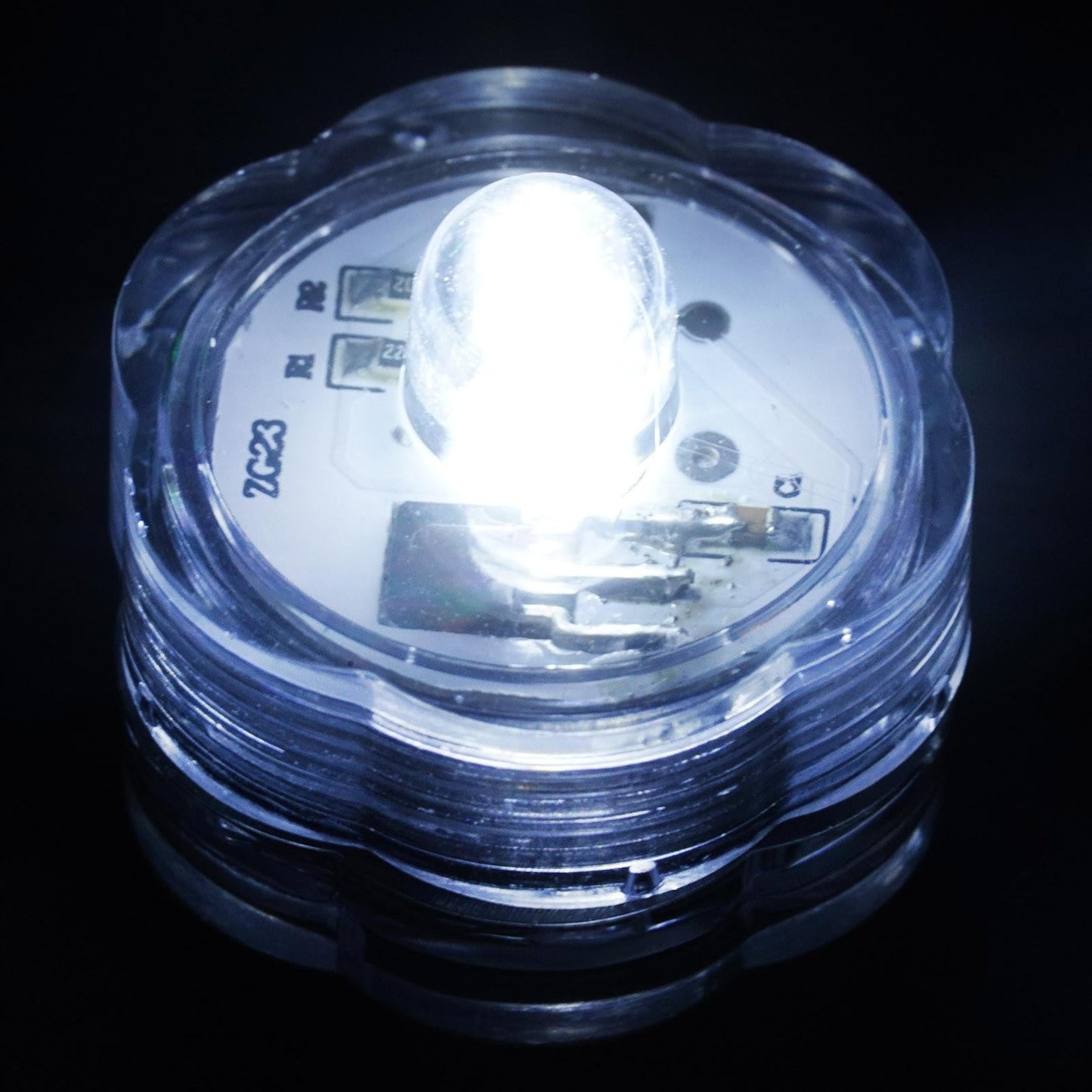 White waterproof submersible LED light, remote operated, for indoor or outdoor use.