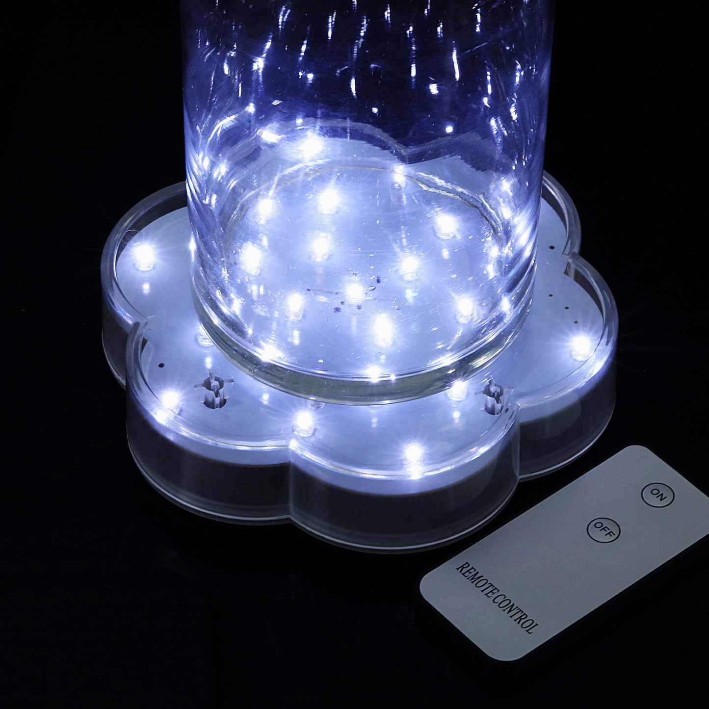 White flower-shaped LED disc lights with remote control.