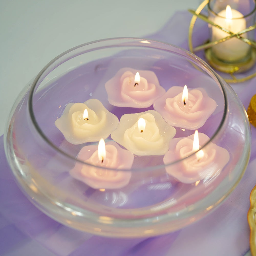 Floating candle centerpiece in a clear glass bowl with pink and white candles.