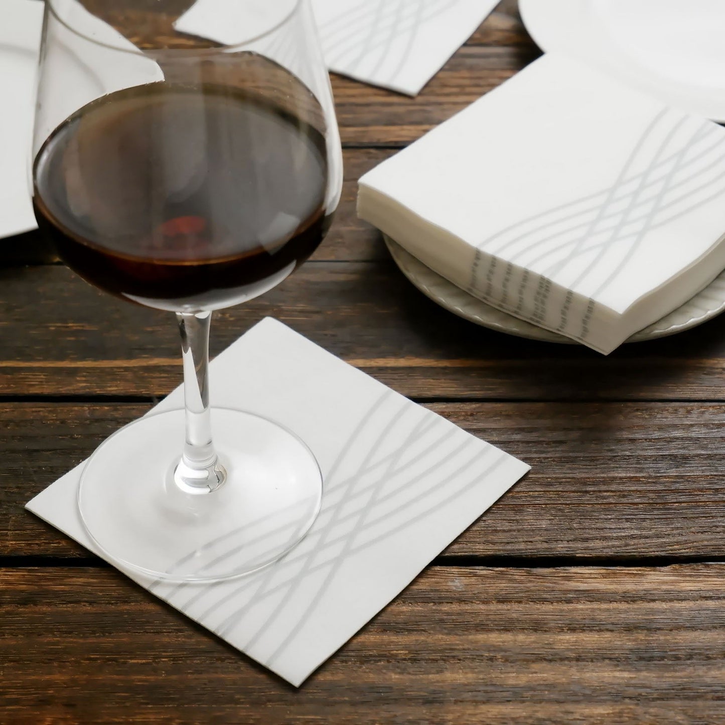 White linen-feel cocktail napkins with silver waves print.
