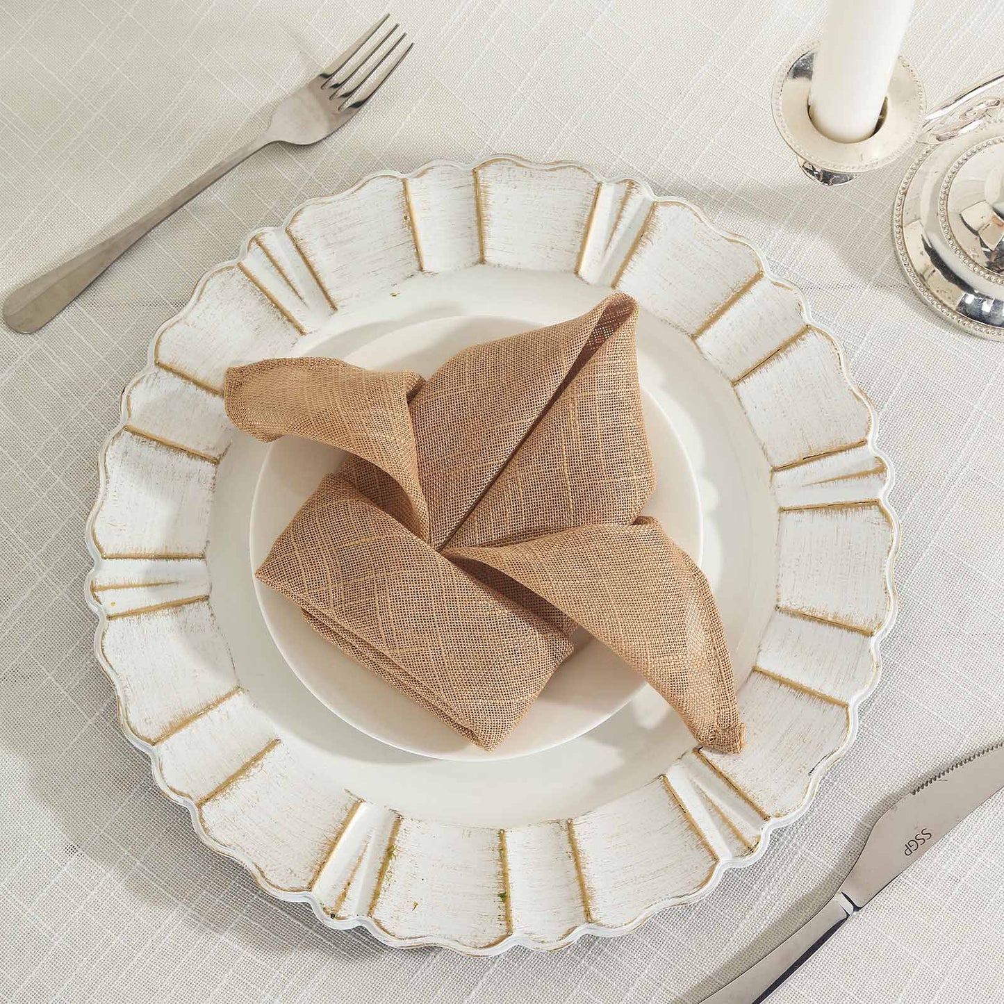 Natural slubby textured cloth dinner napkins in a warm beige tone.
