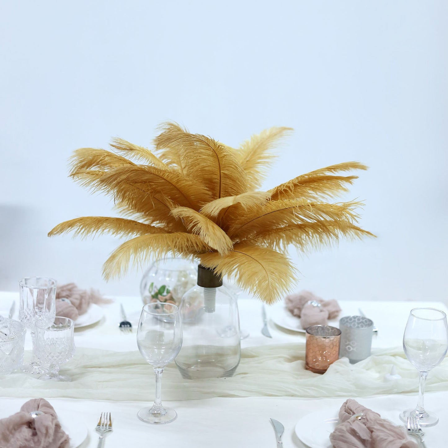 Gold natural plume ostrich feathers in a decorative centerpiece.