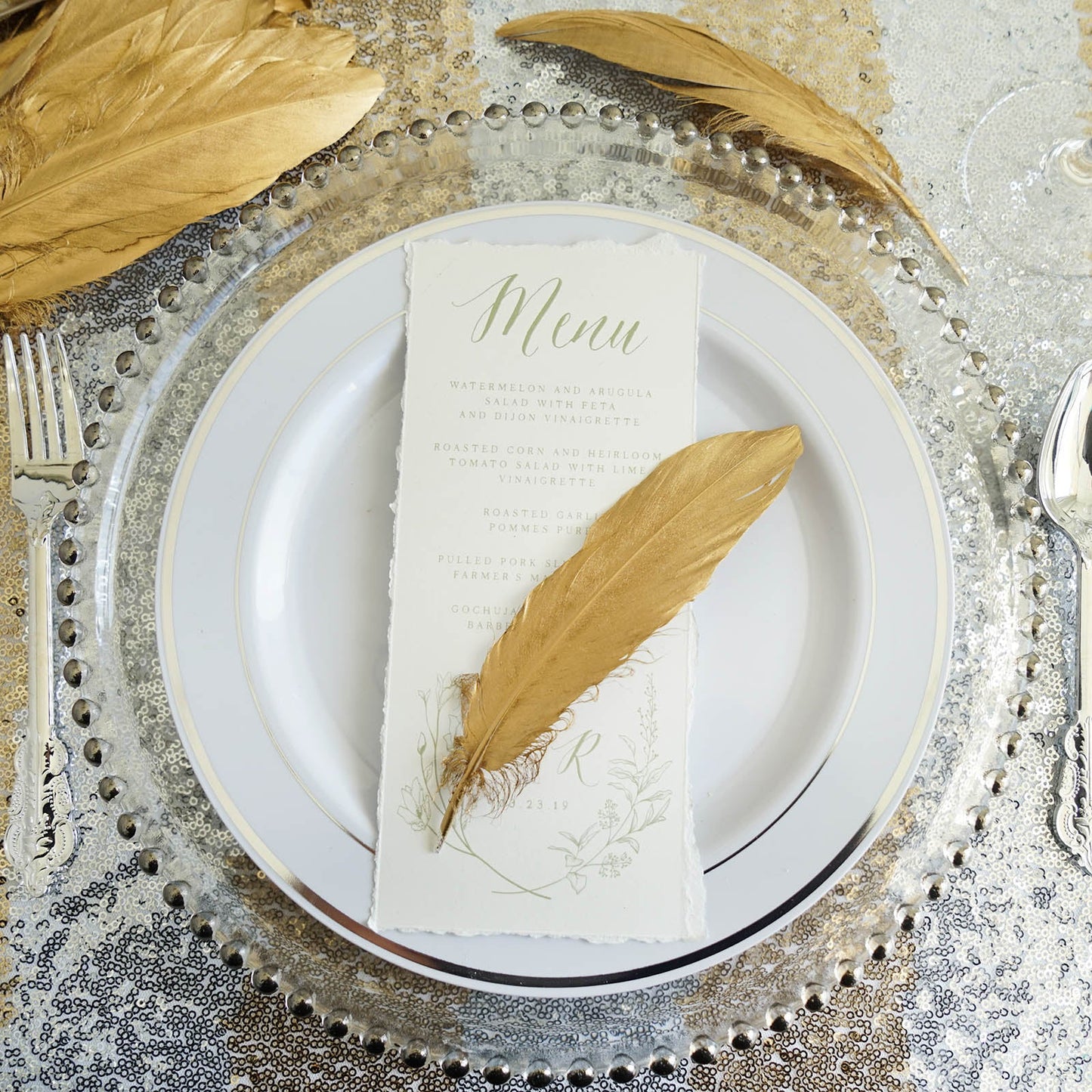 Metallic gold natural goose feathers for party decoration on a table setting.