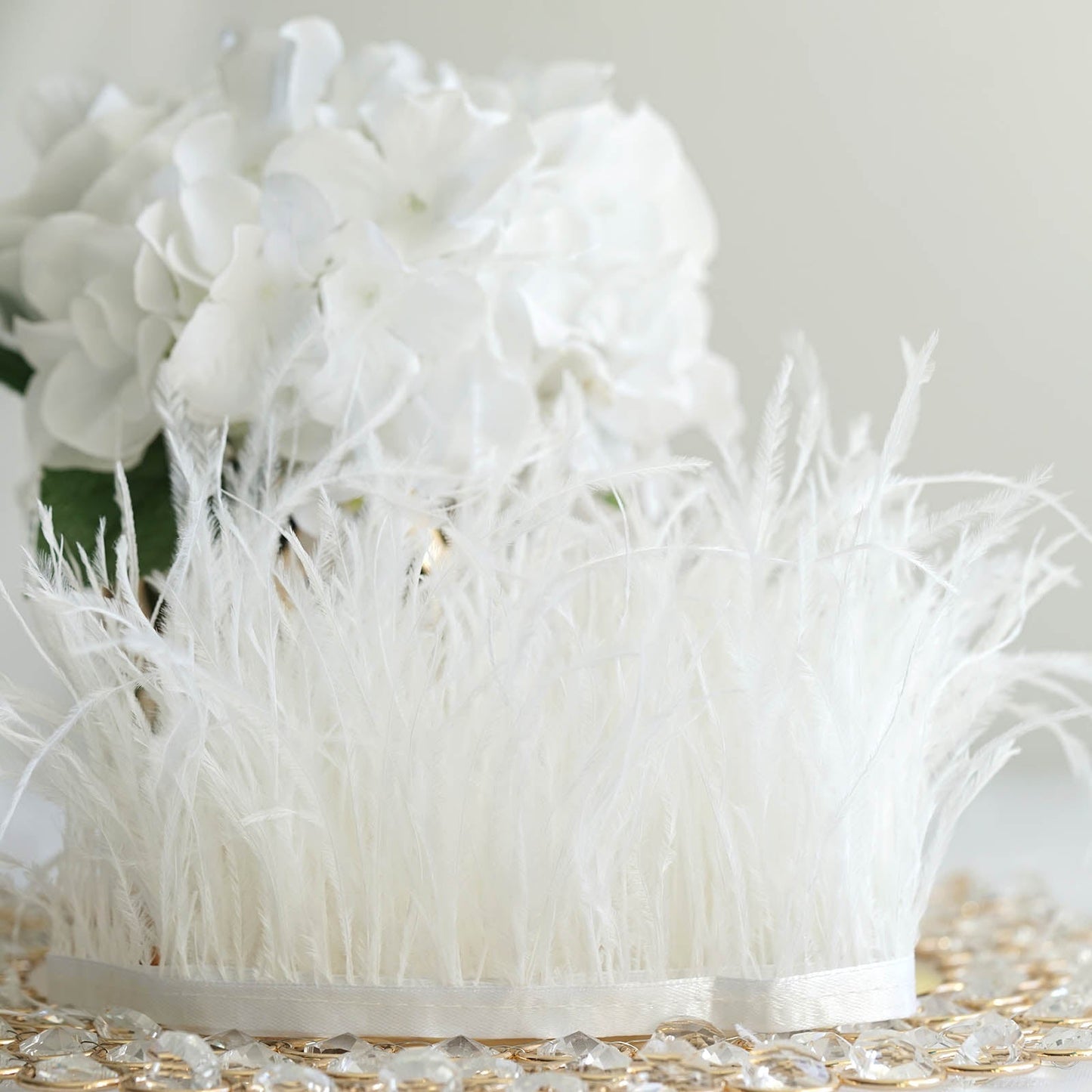 White ostrich feather fringe trim with satin ribbon tape.