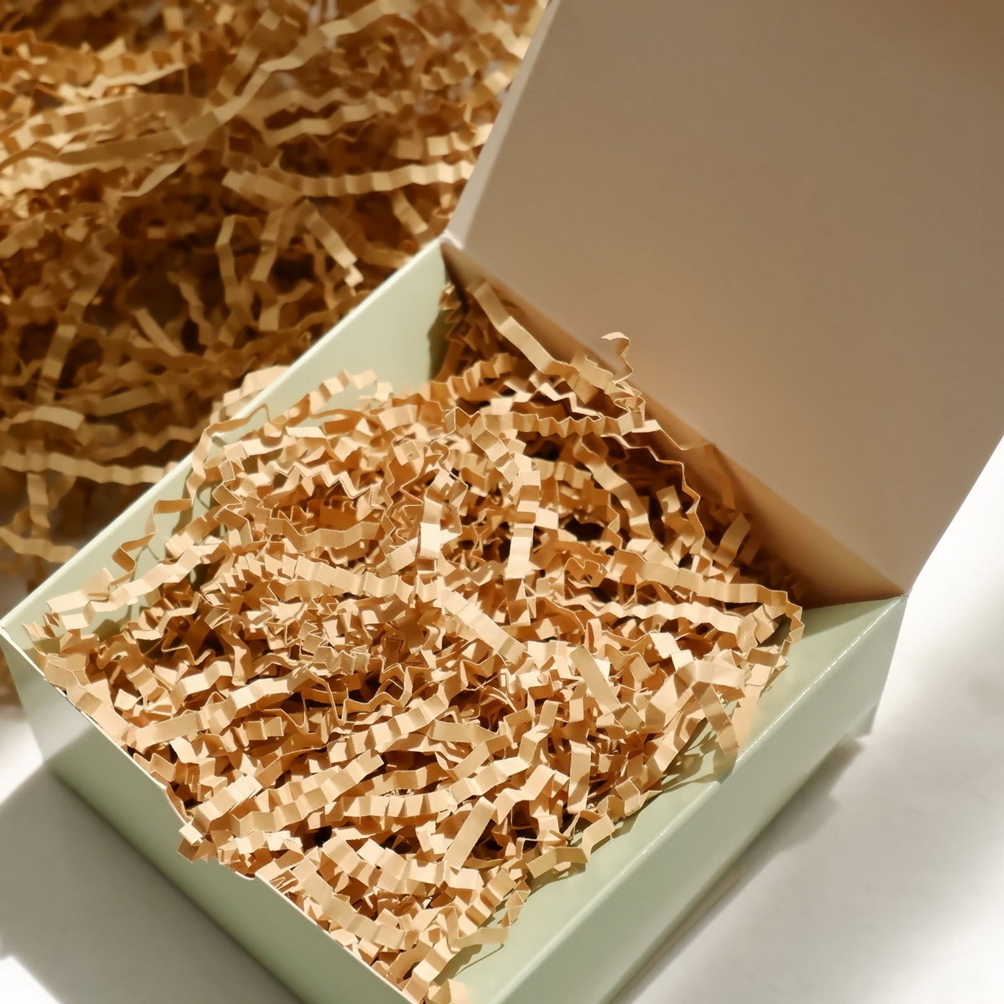 Natural brown paper shred basket filler in a gift box.