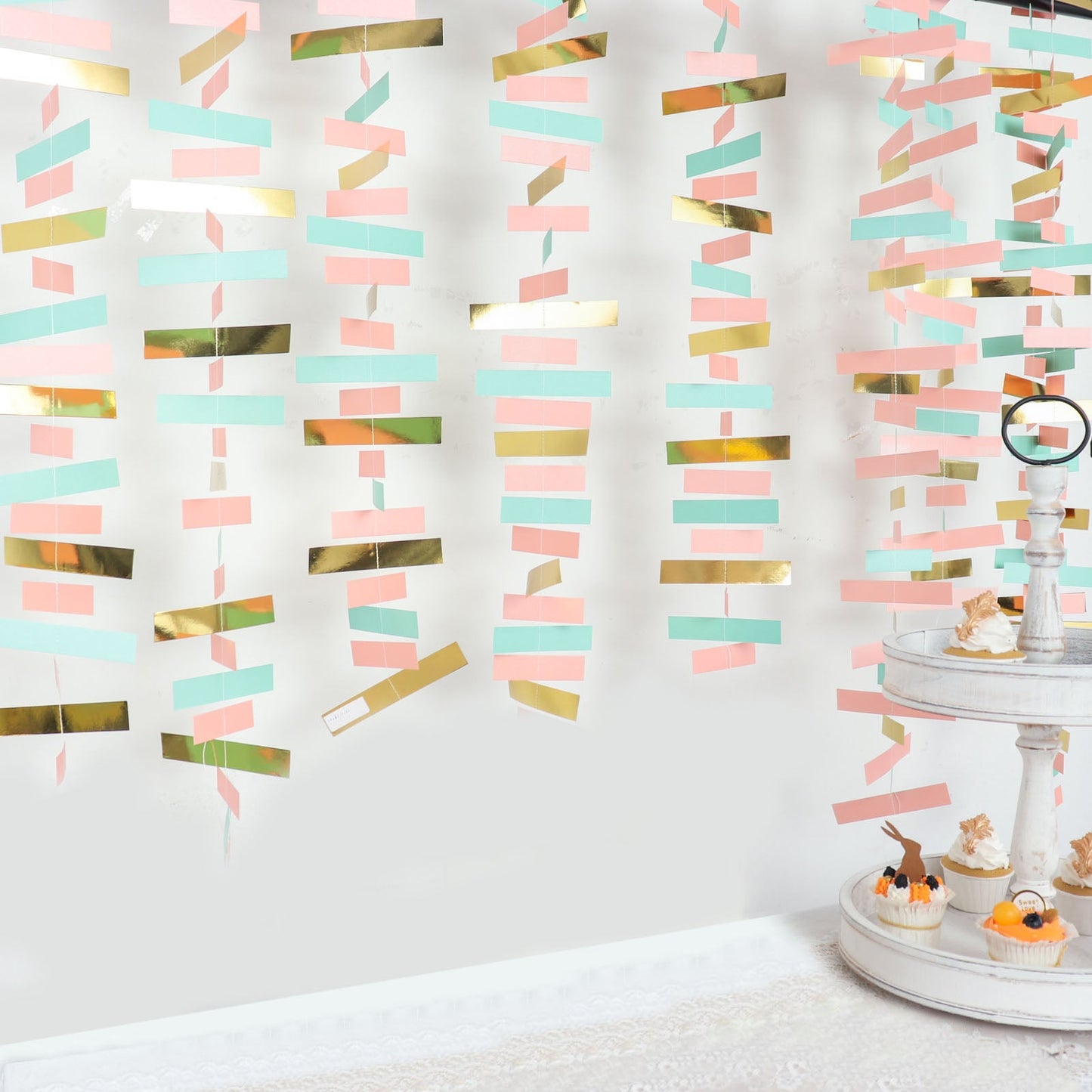 Gold, blush, and turquoise paper garland streamer backdrop decoration.