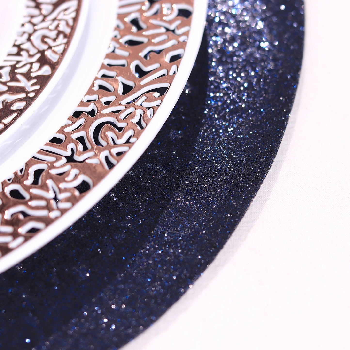 Navy blue sparkle vinyl placemats on a decorative table setting.