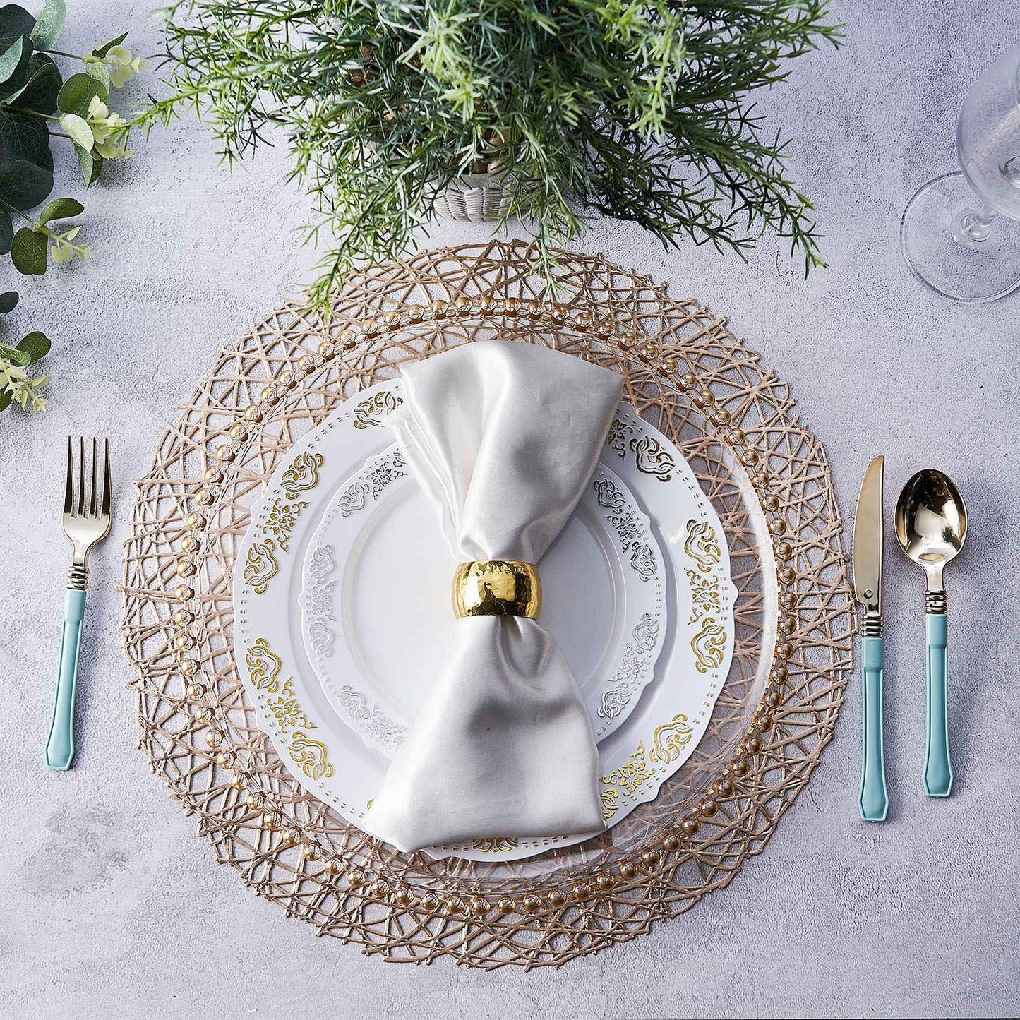 Champagne metallic vinyl placemats on a beautifully set table.