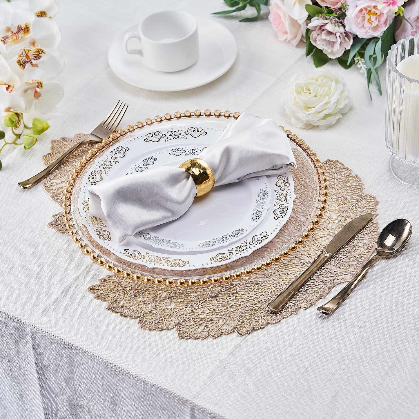 Gold metallic fall leaf vinyl placemats on a dining table setting.