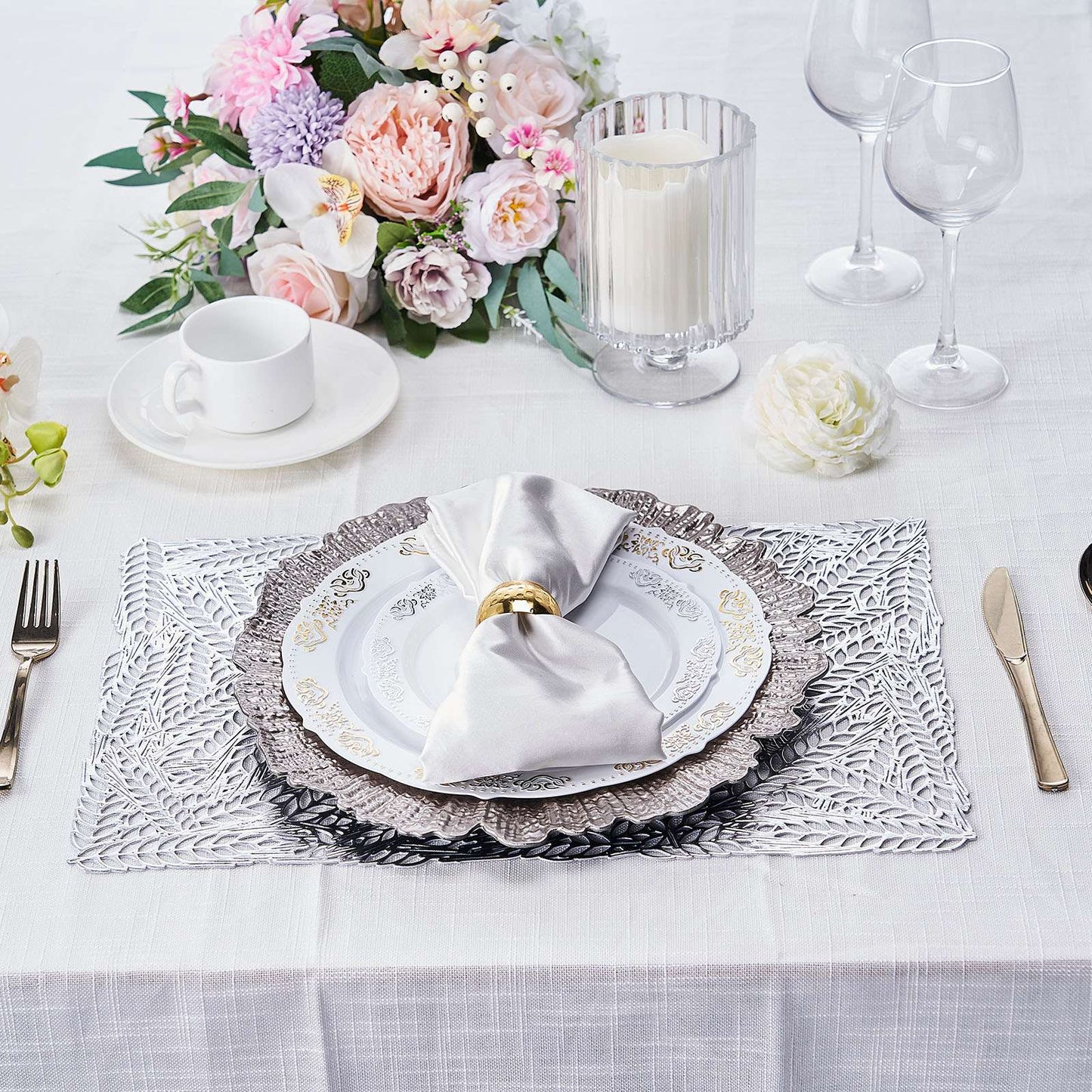 Silver vinyl placemats with a metallic wheat design on a dining table setting.