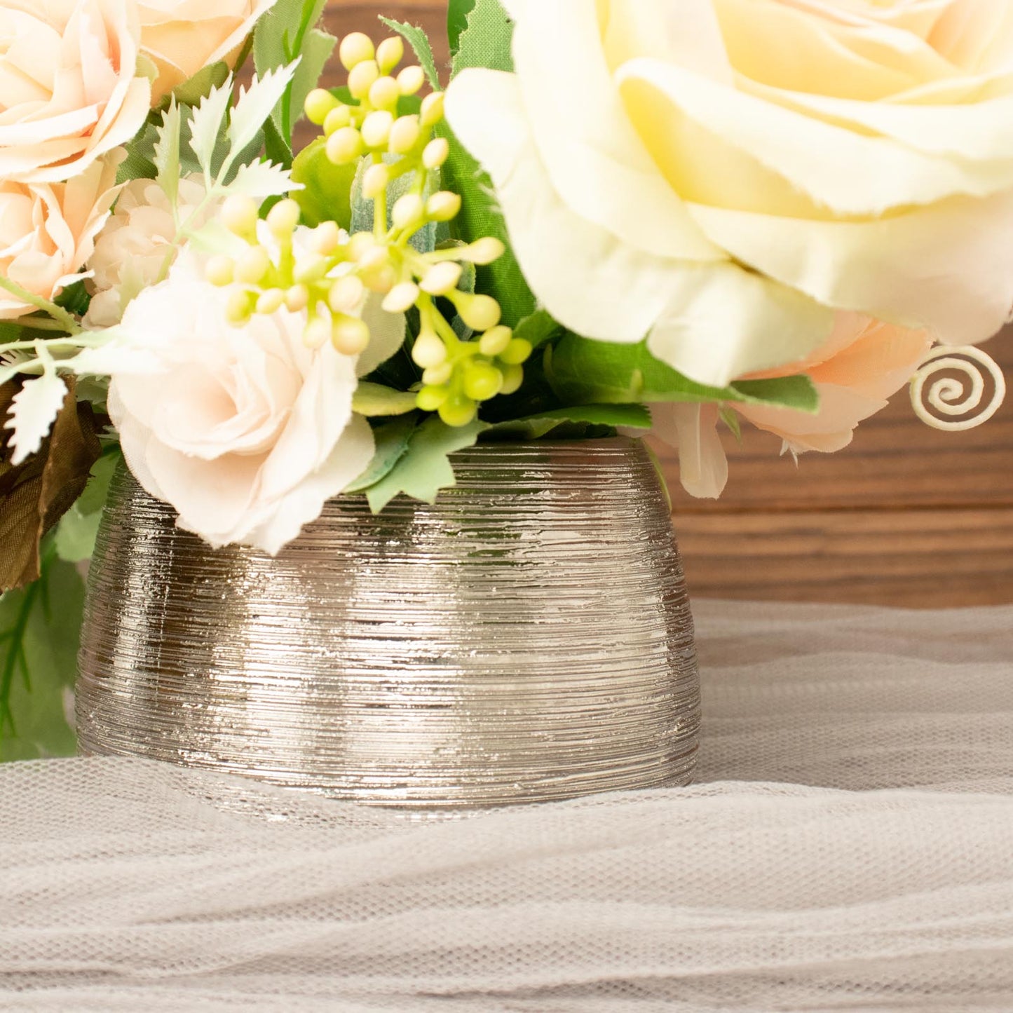 Silver textured ceramic flower vase pot with pink and white flowers.