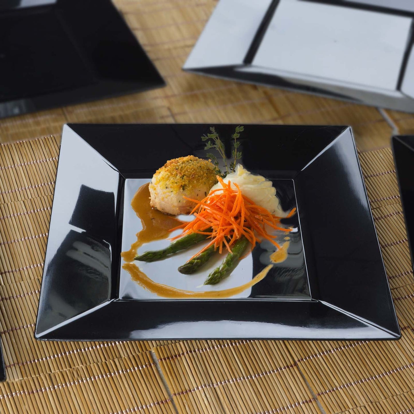 Modern black square disposable dinner plate with glossy finish, featuring a plated dish.