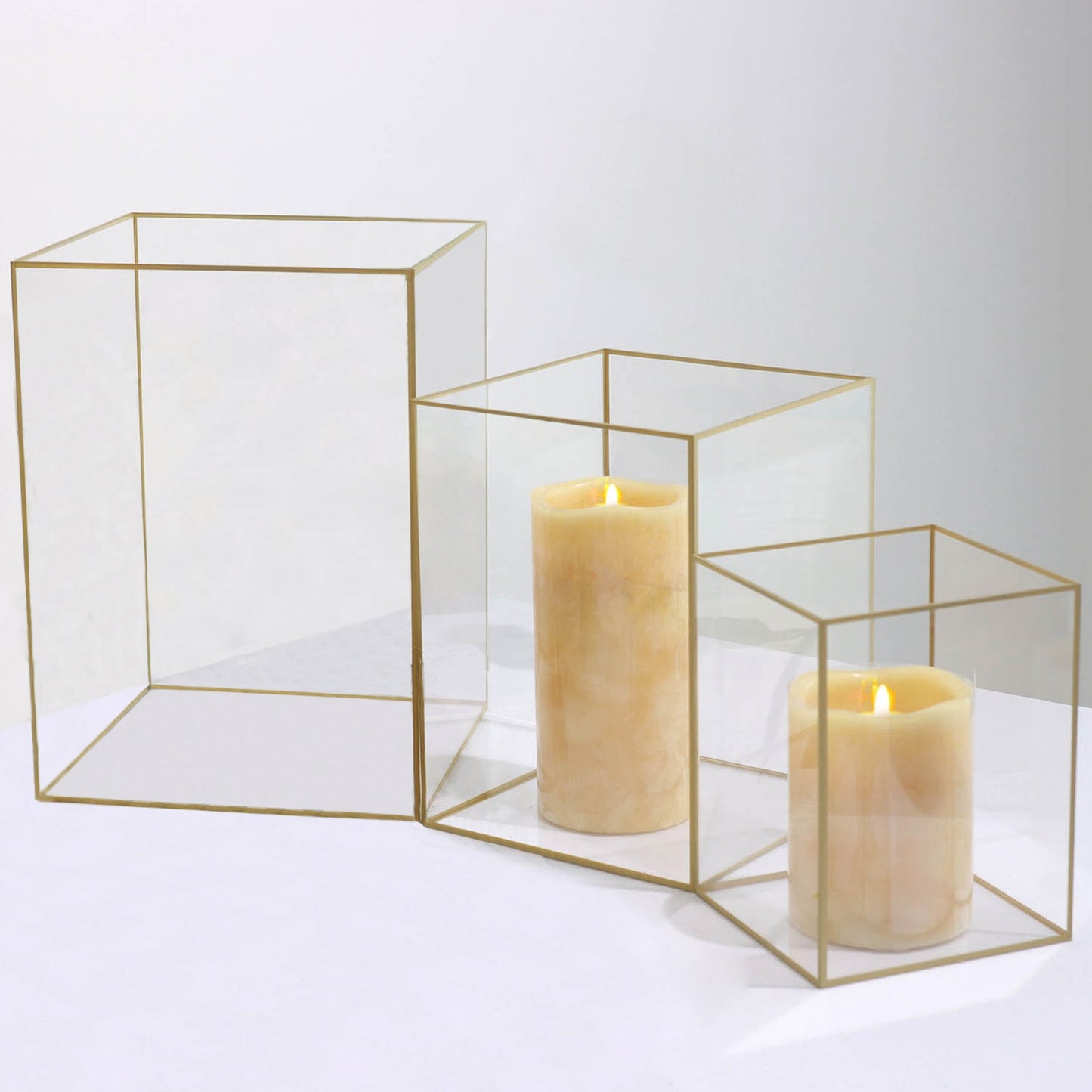 Clear acrylic candle holders with gold rims, perfect for floral displays.