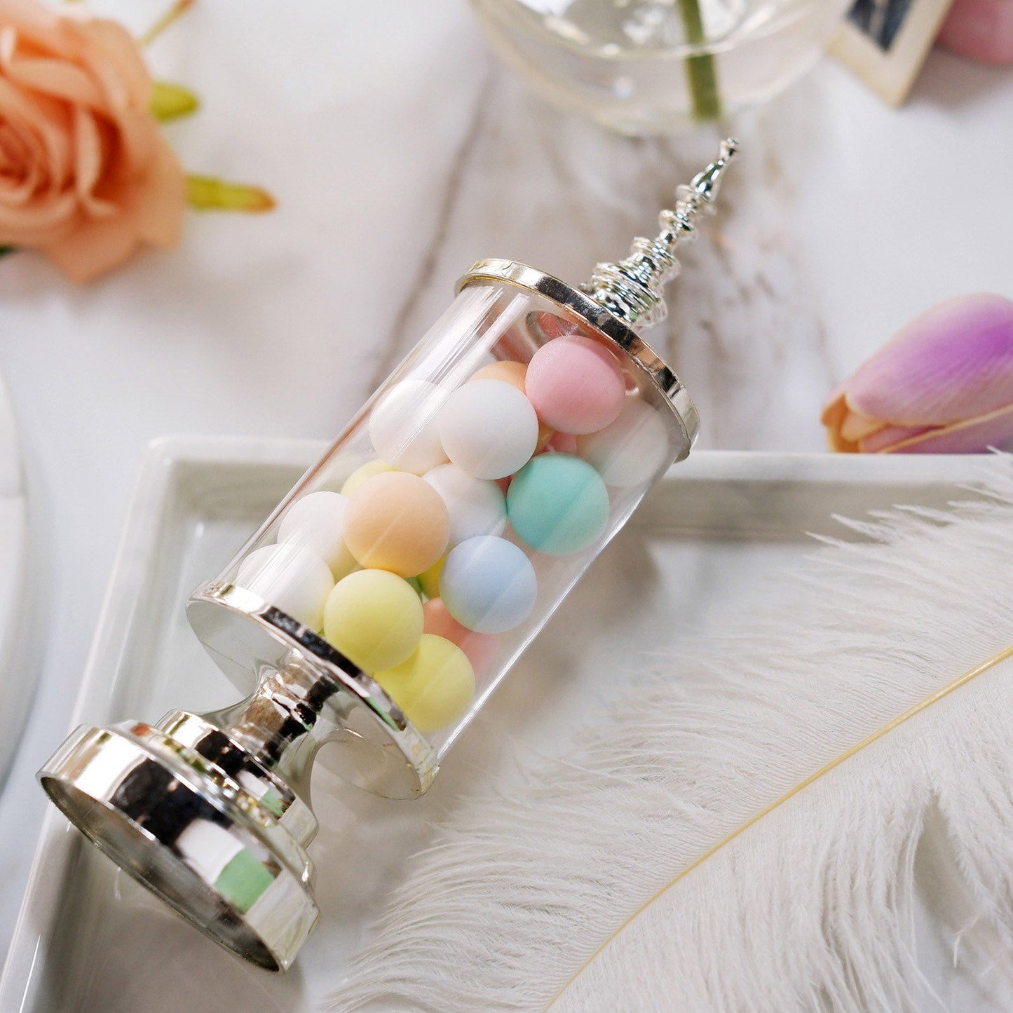 Silver pedestal candy treat jar filled with pastel colored candies.