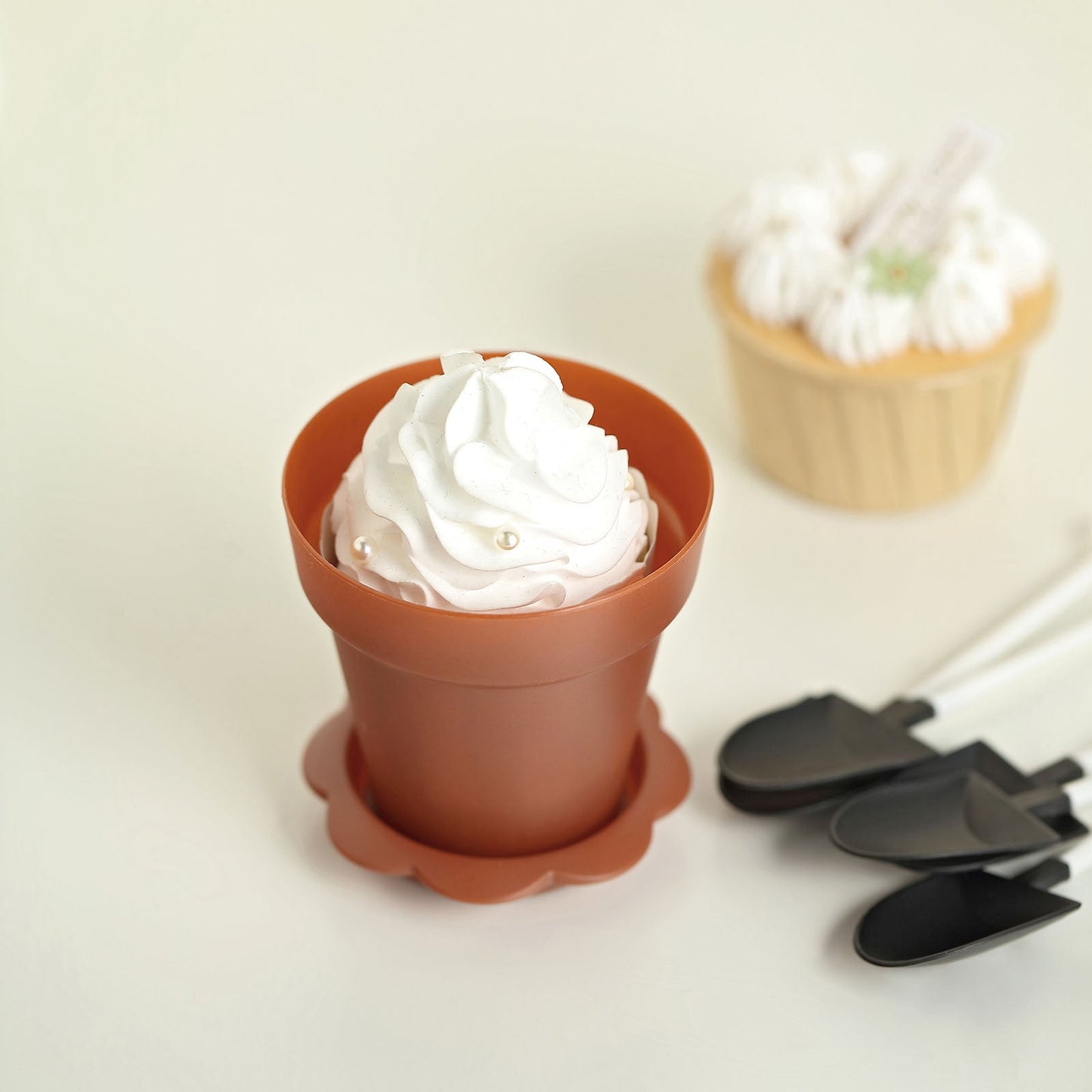 Terracotta succulent planter pot with clear lid and shovel.