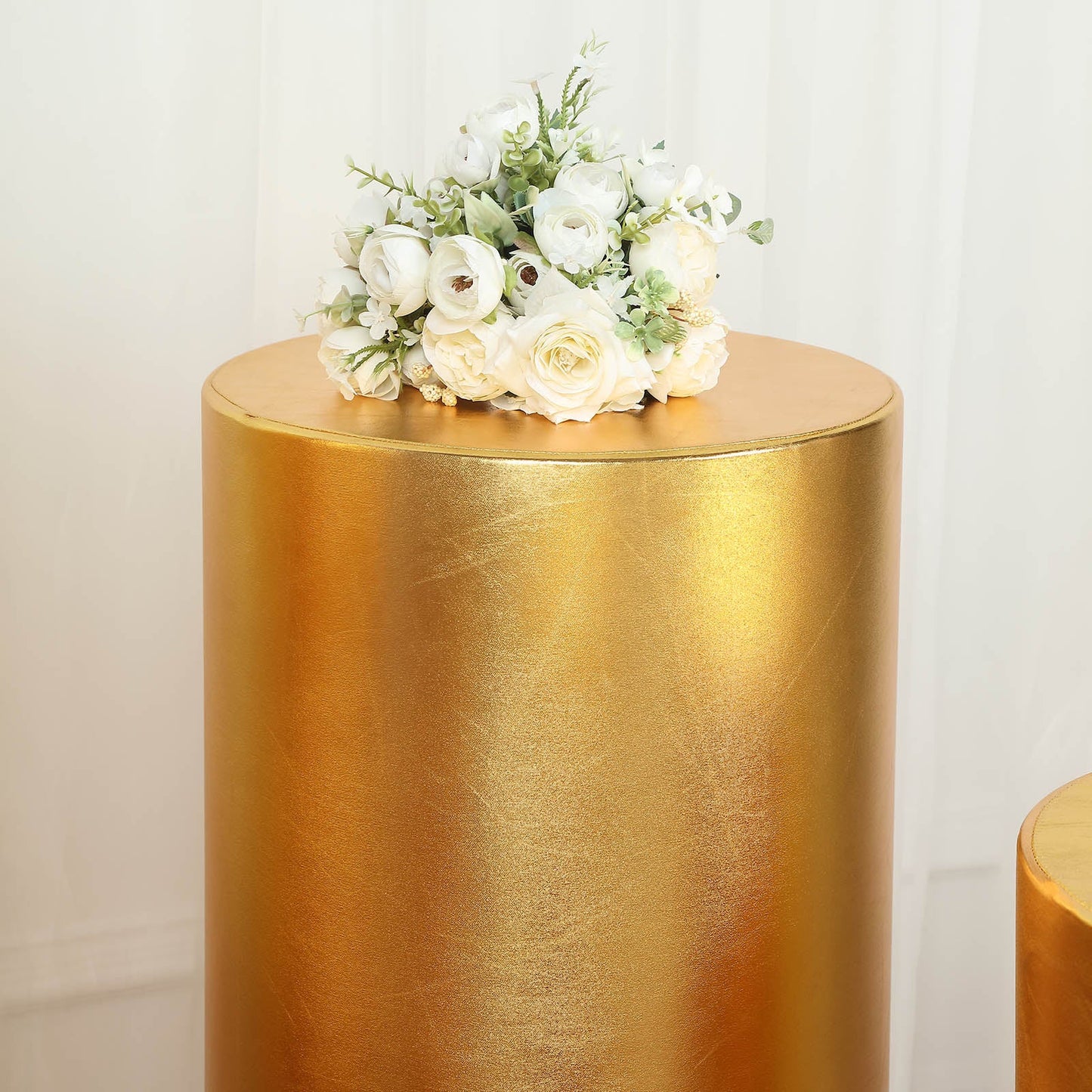Metallic gold pedestal stand covers with shiny stretchable design.